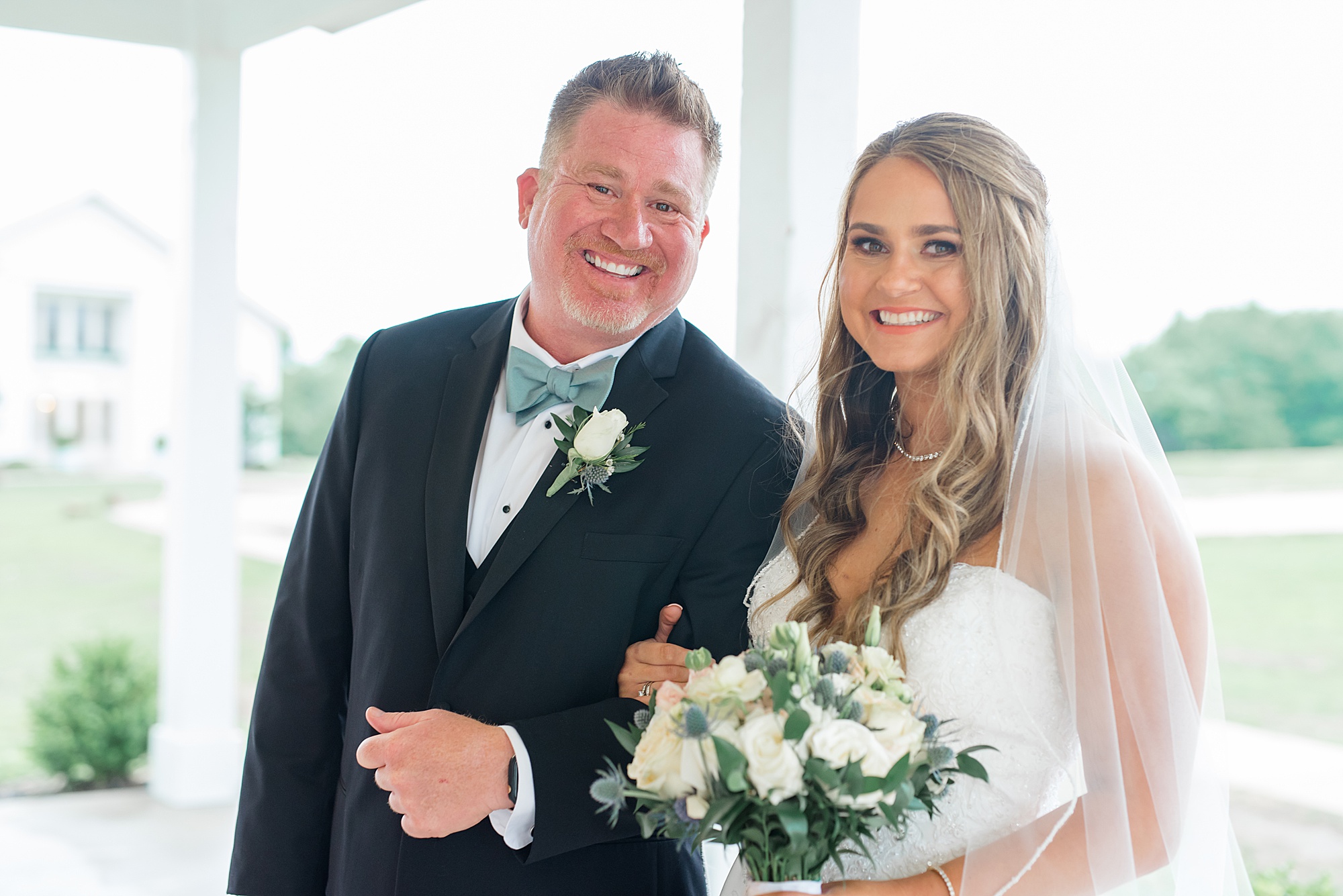 bride and dad smile before walking down aisle