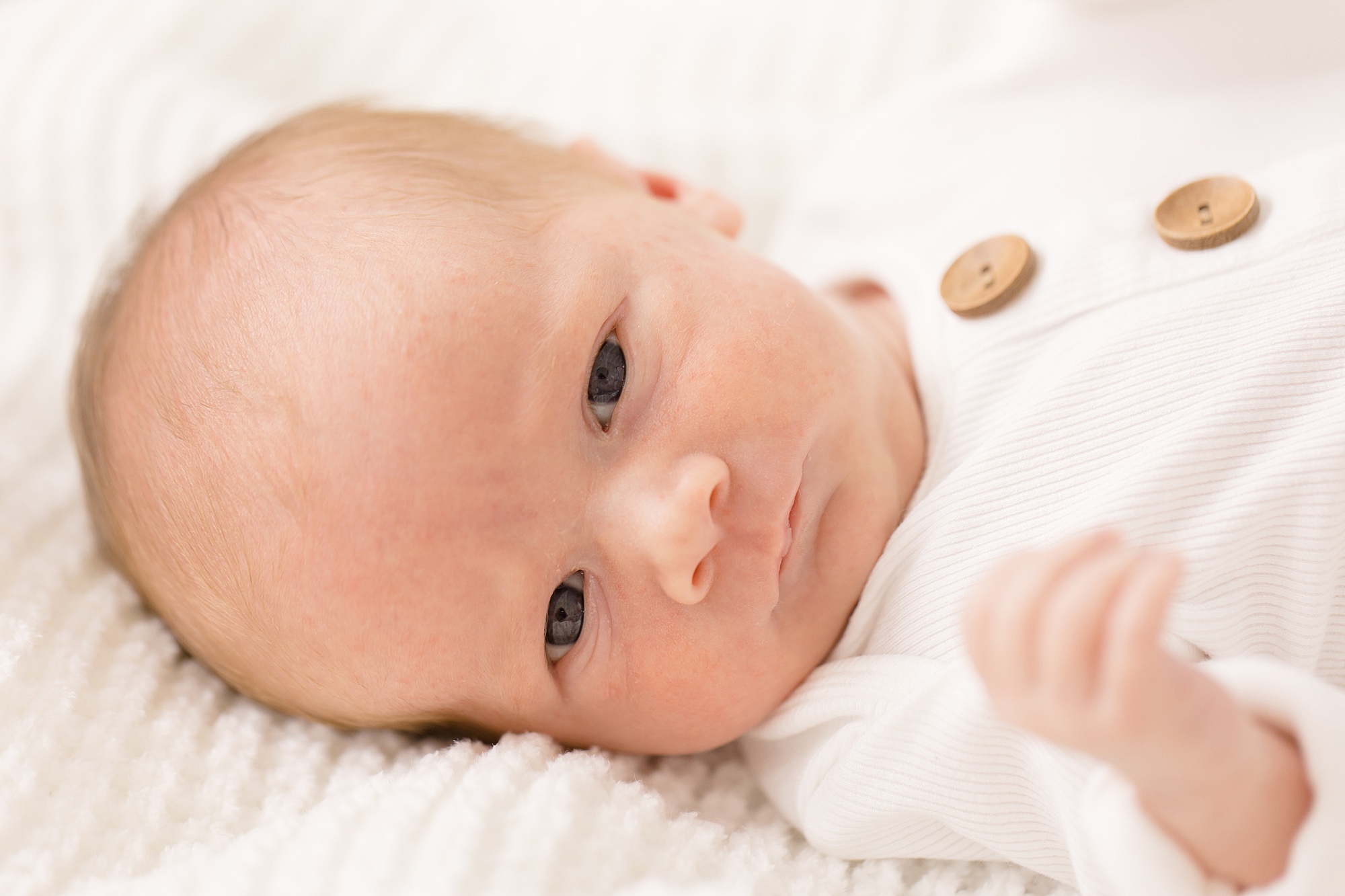 Lifestyle Newborn Session at The Nest at Ruth Farms for baby boy in white onesie