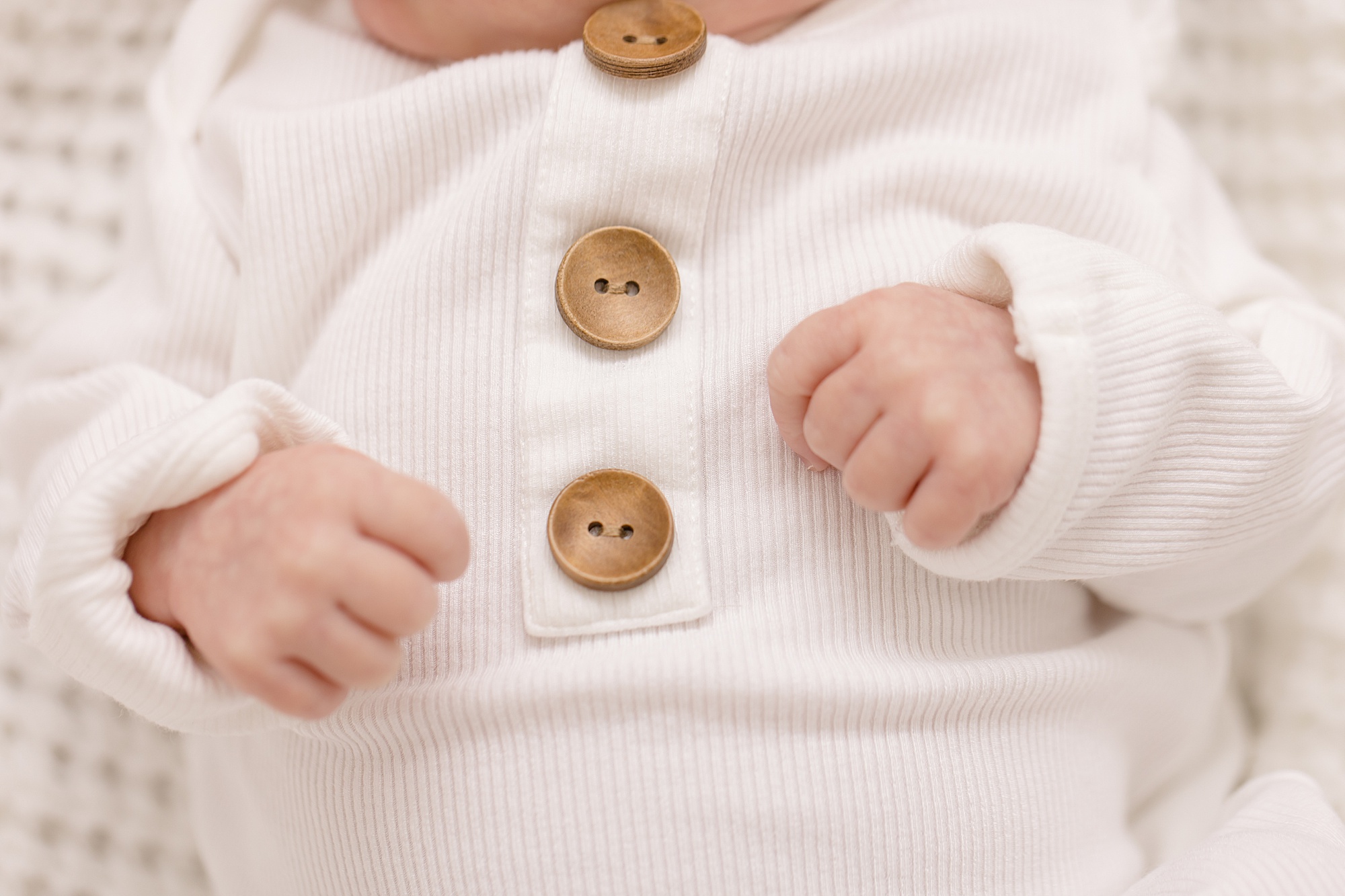 baby's white onesie buttons