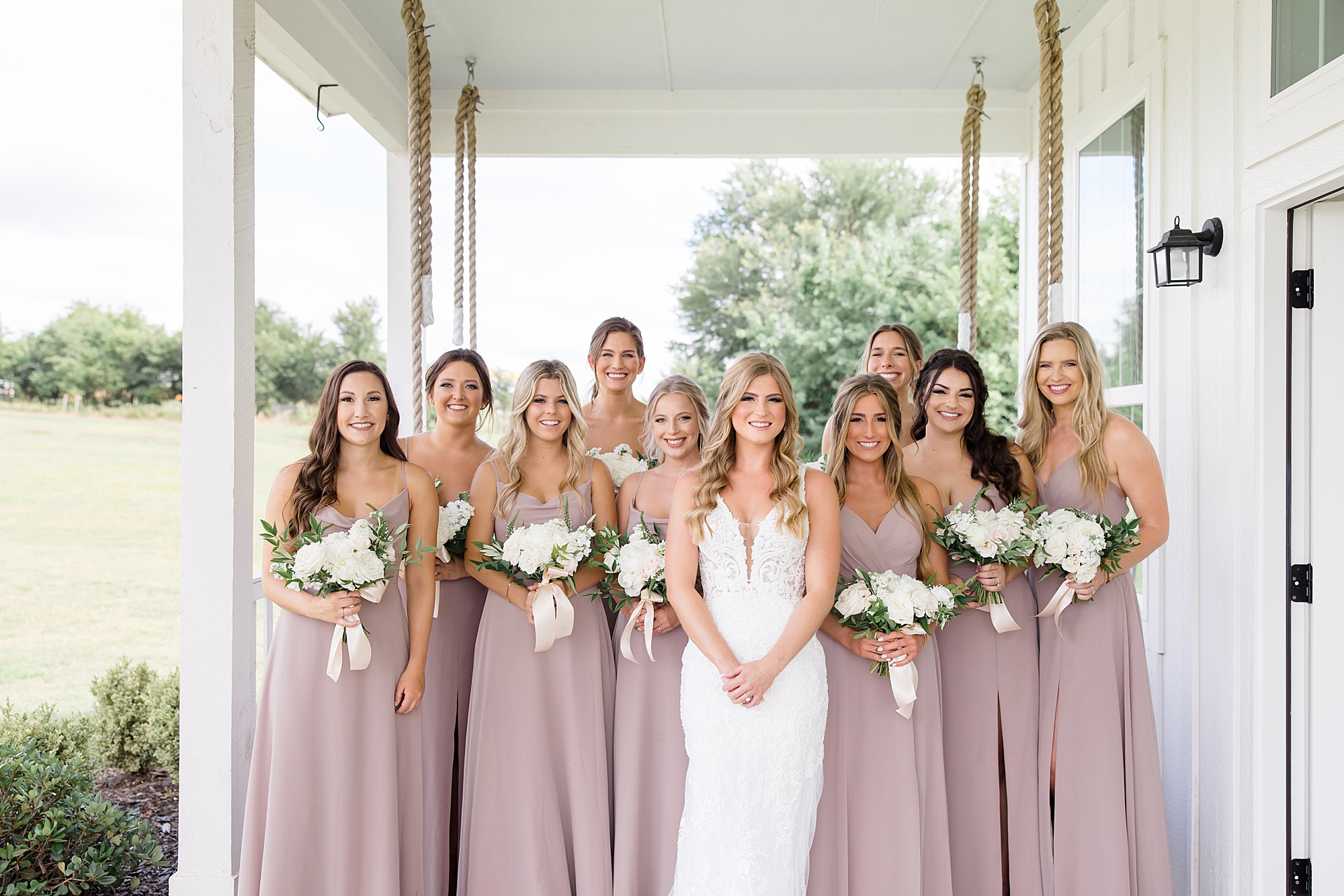 bride poses with bridesmaids in mauve gowns for Summer Wedding at The Grand Ivory