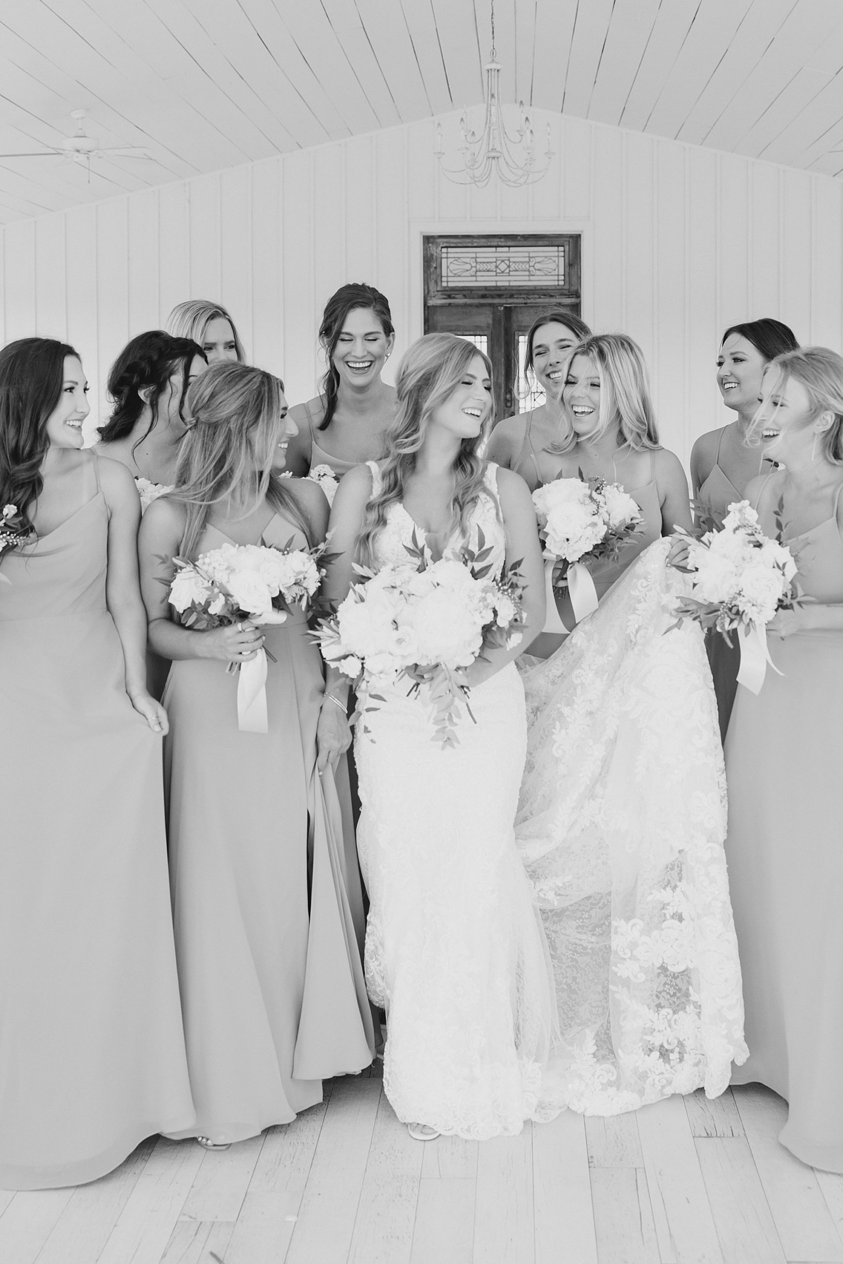 bride and bridesmaids laugh in outdoor chapel at The Grand Ivory