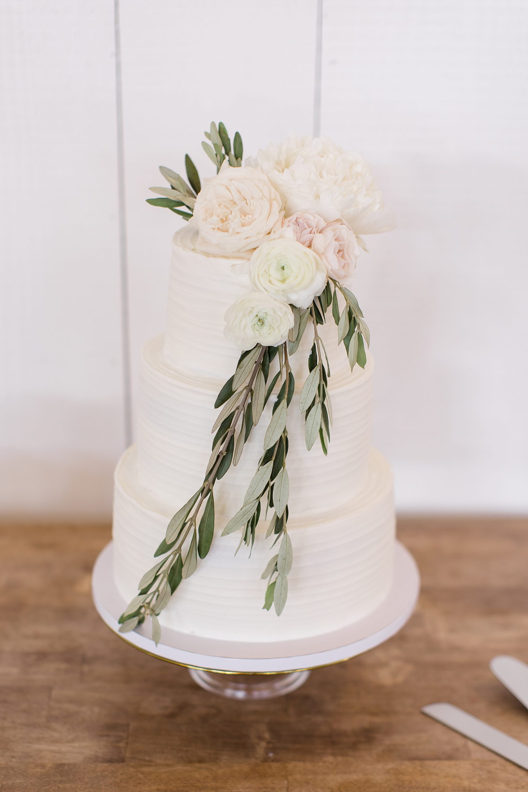 tiered wedding cake with flowers on top