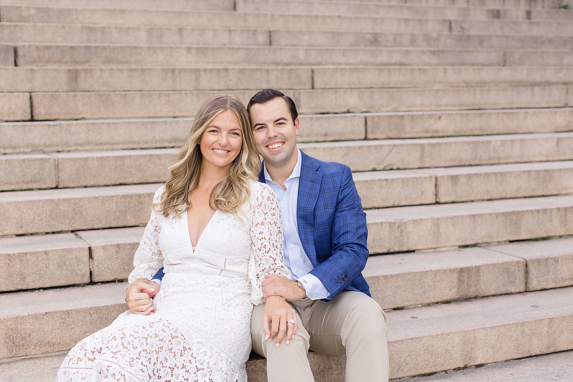 engaged couple sits on steps in Central Park
