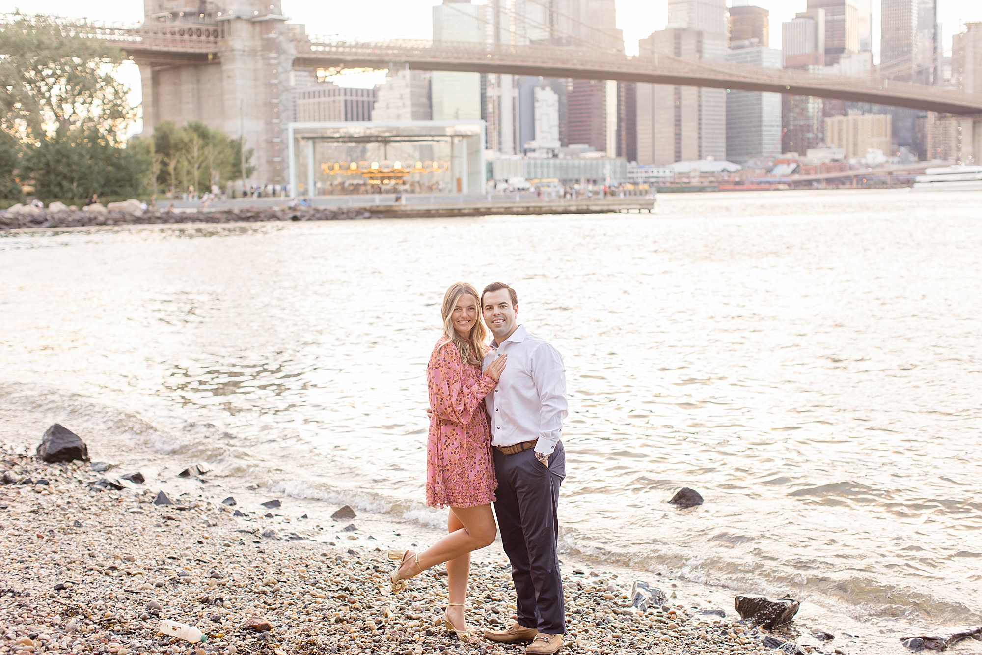 DUMBO engagement portraits with Brooklyn Bridge behind them