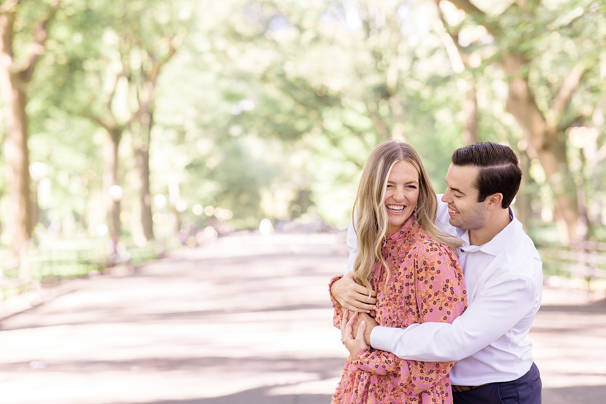 engaged couple laughs together during Central Park engagement session