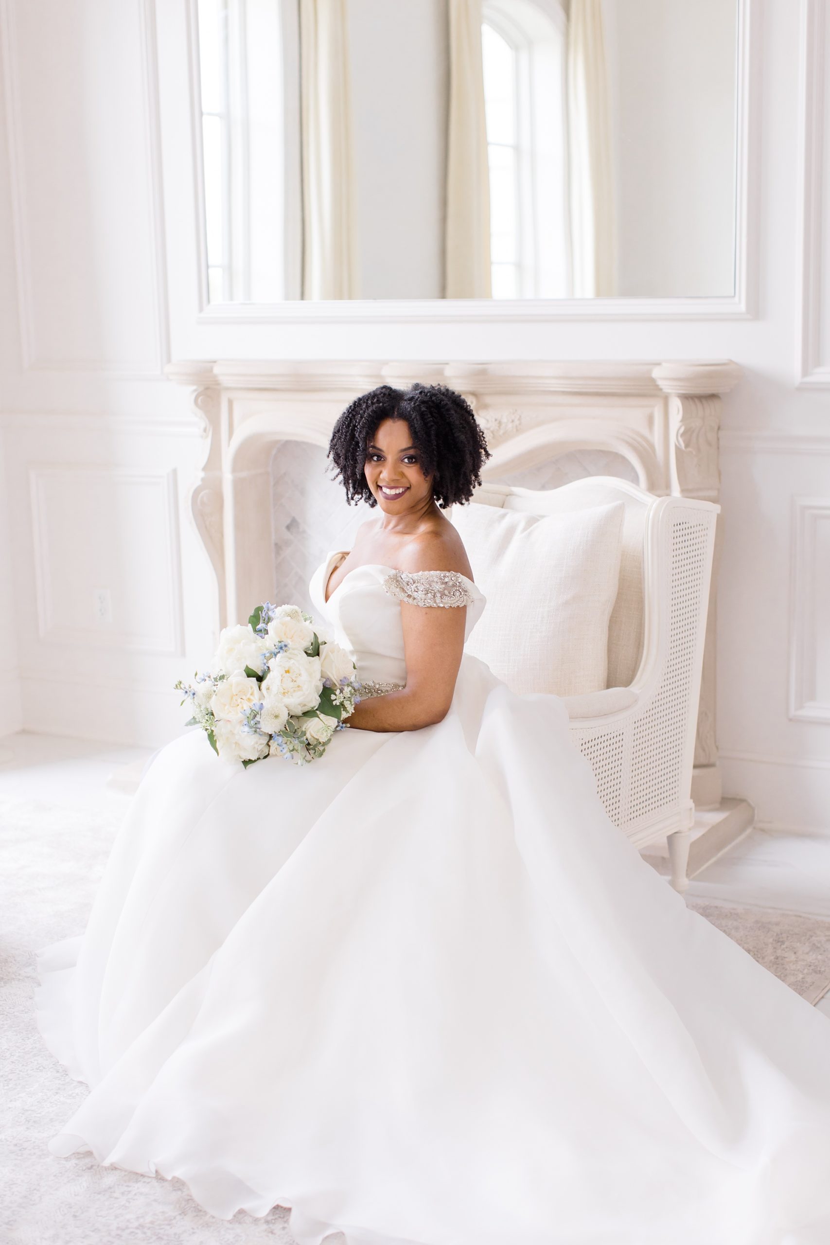 bride sits in chair in bridal suite at The Hillside Estate