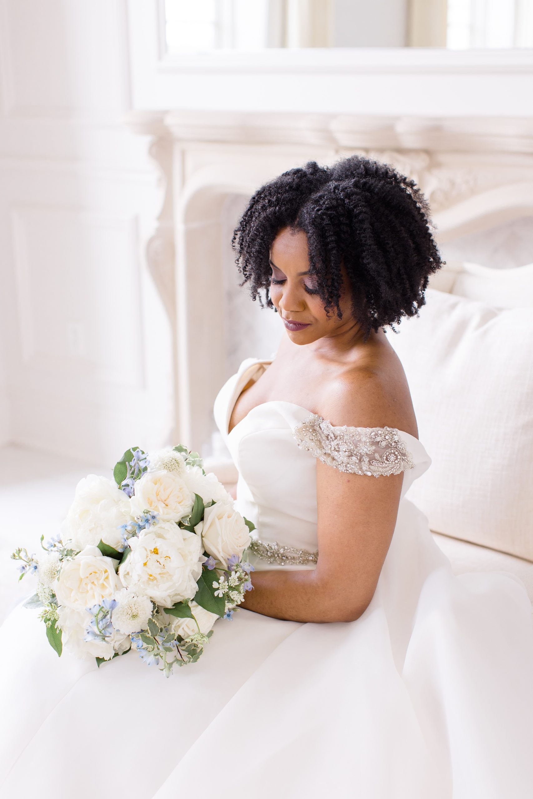bride looks down at bouquet in lap during portraits at The Hillside Estate