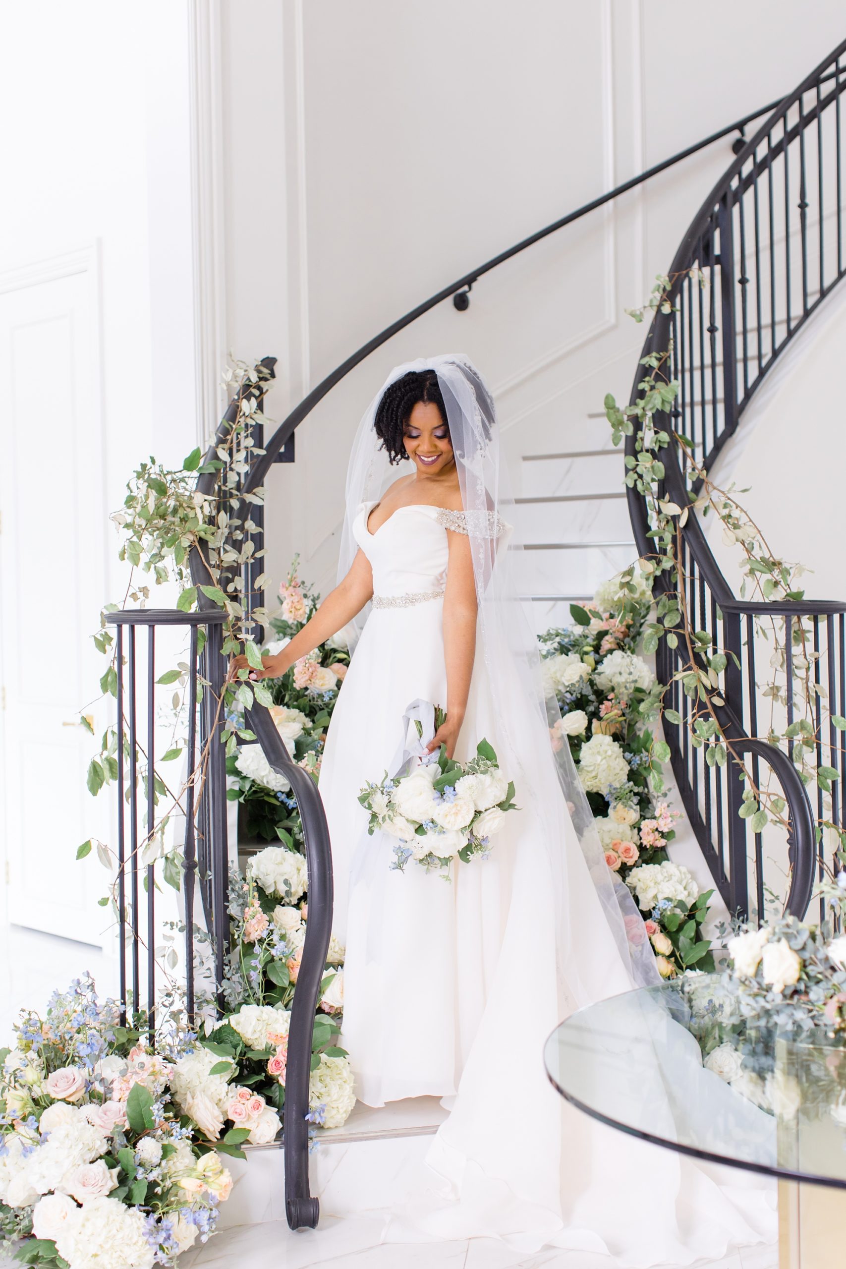 bride poses on staircase at The Hillside Estate
