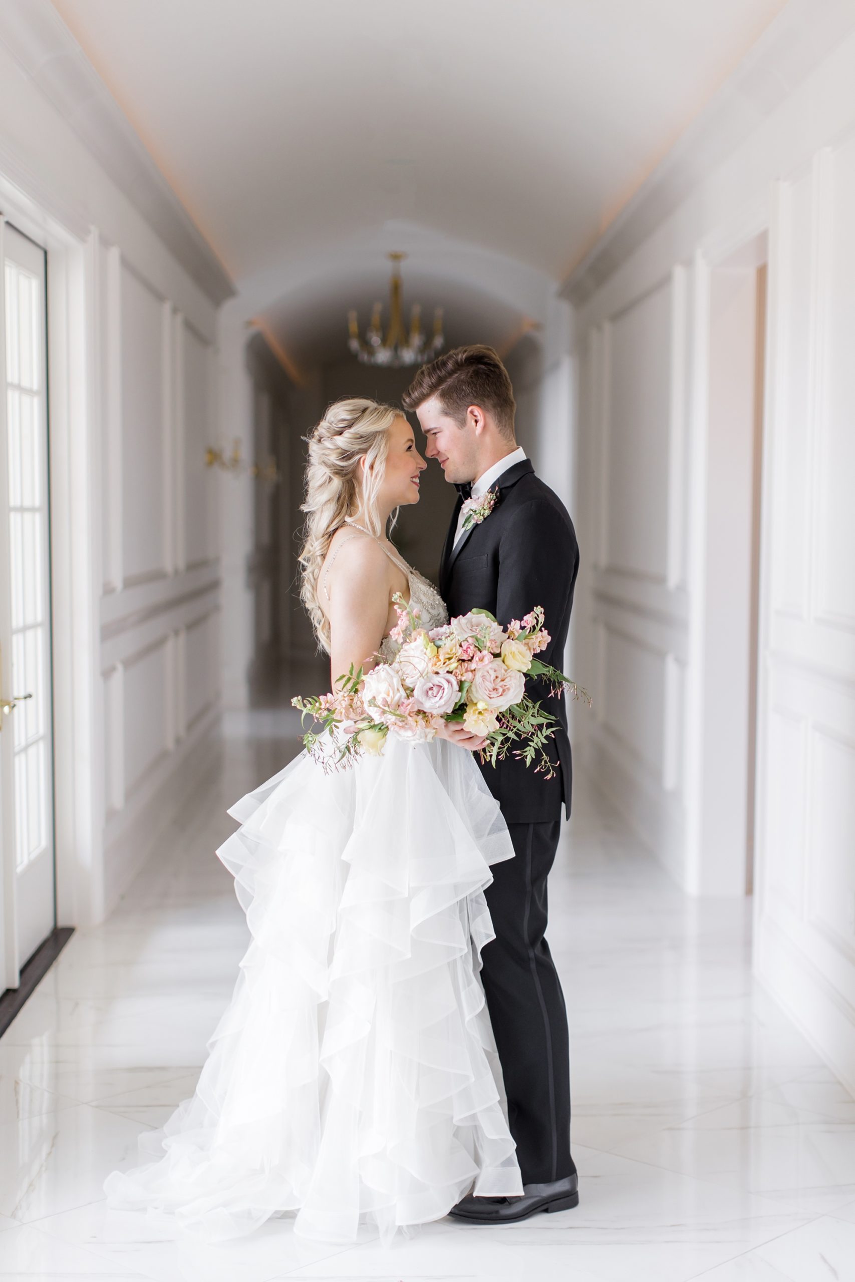 bride and groom pose in hallway of The Hillside Estate during photos