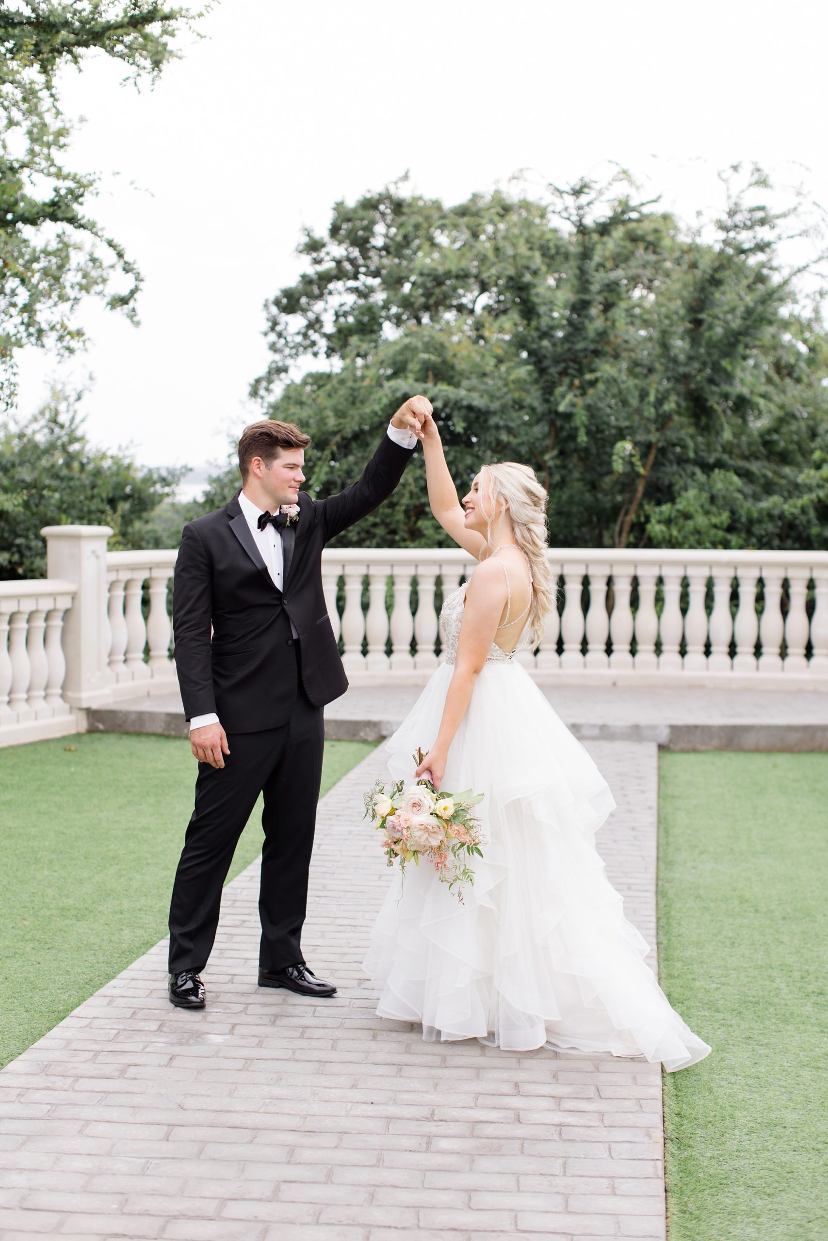 groom twirls bride during photos at The Hillside Estate
