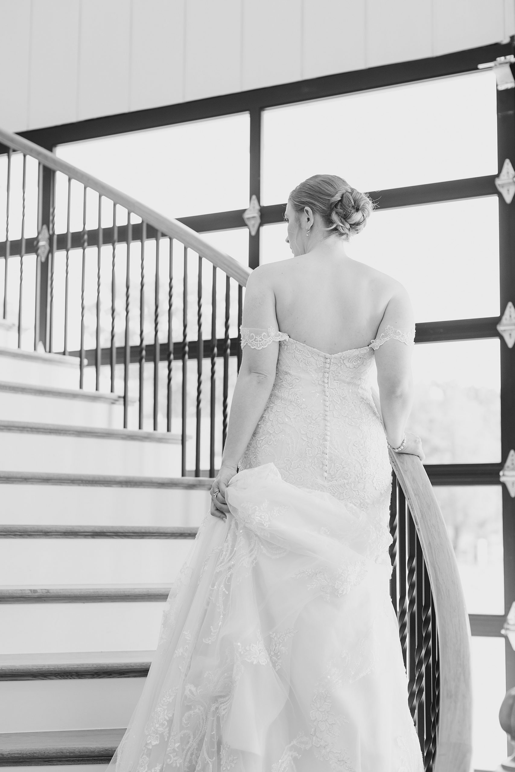 bride climbs staircase in Texas venue