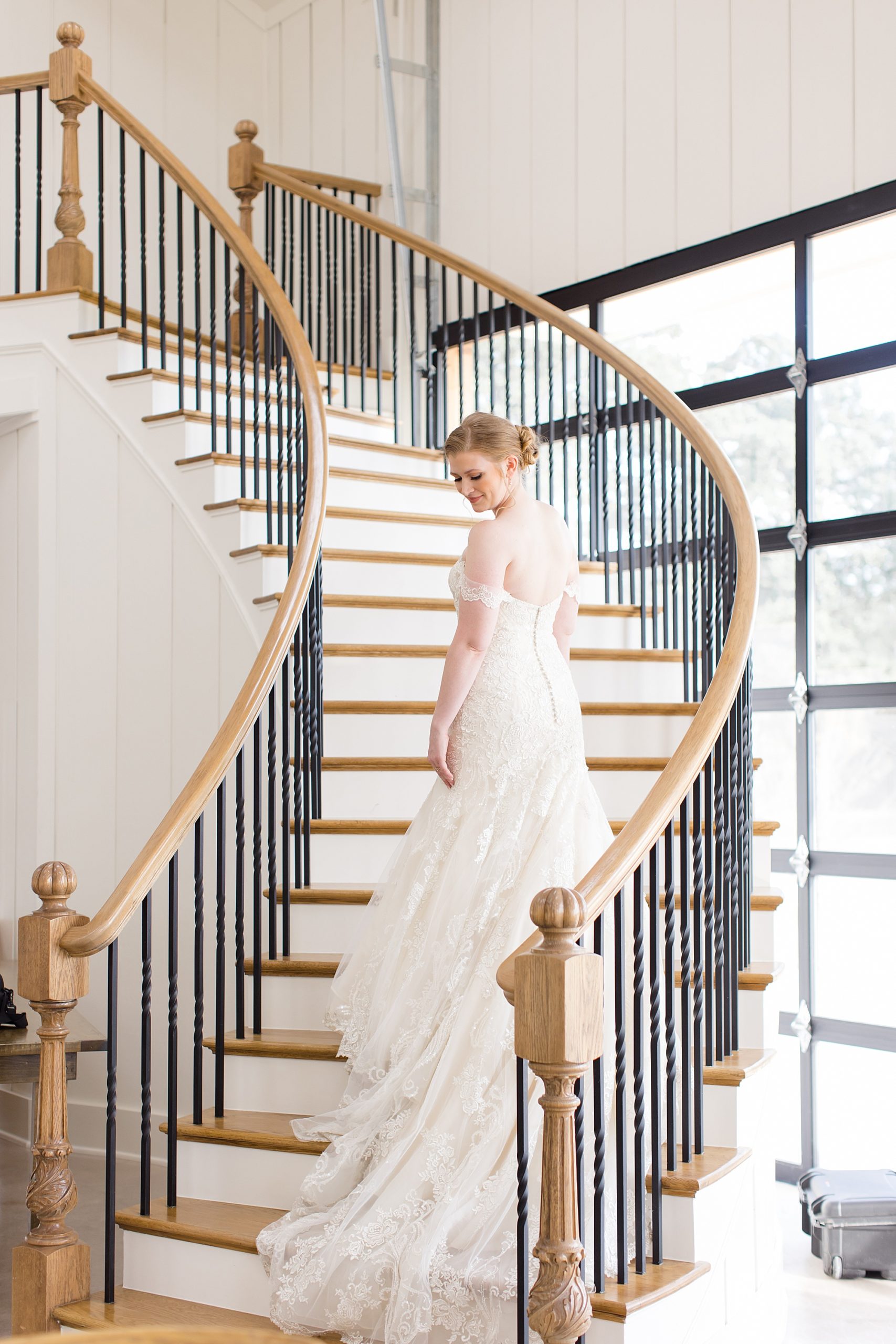 bride poses on staircase at Bella Cavalli
