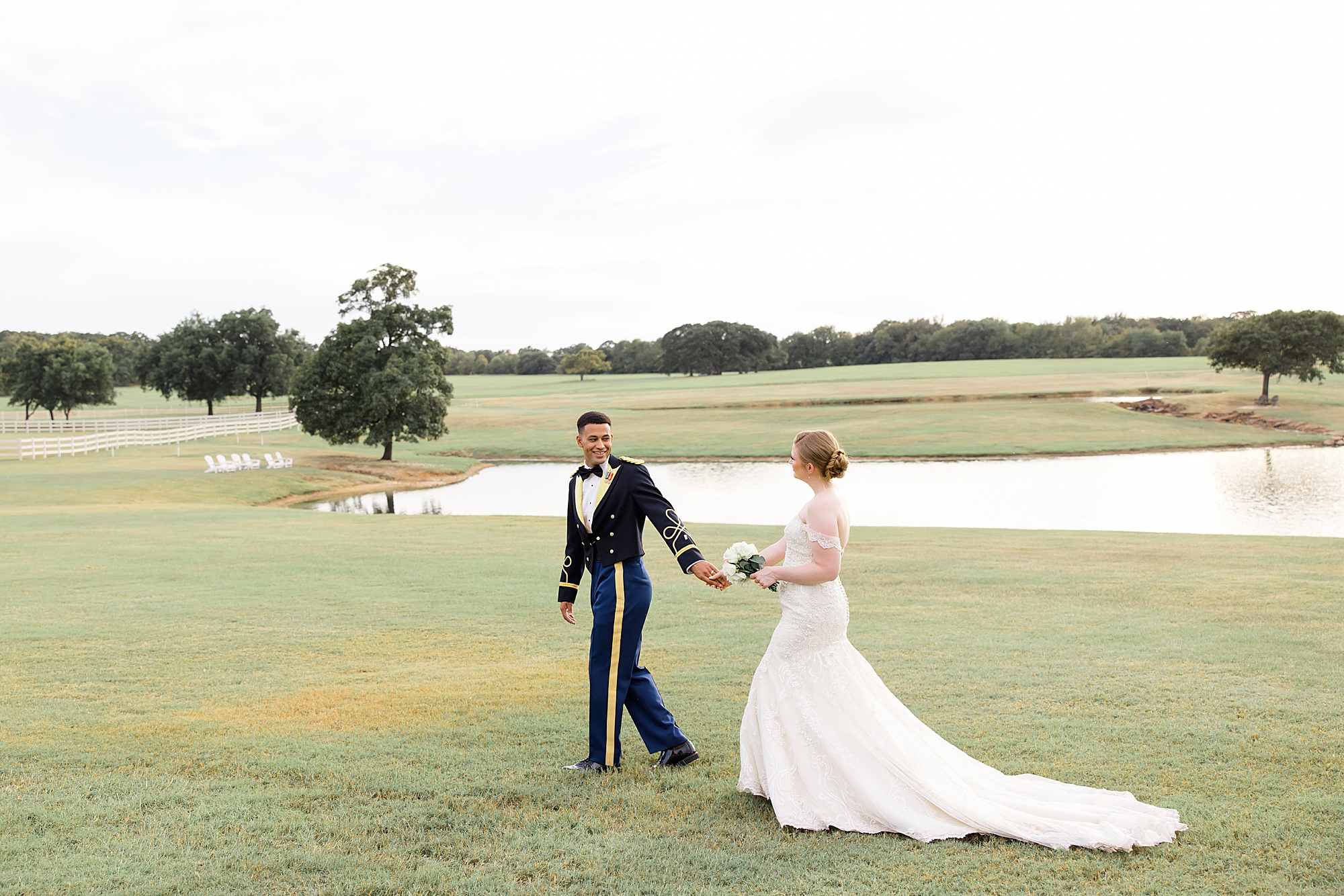 bride and groom walk by pond in Aubrey TX