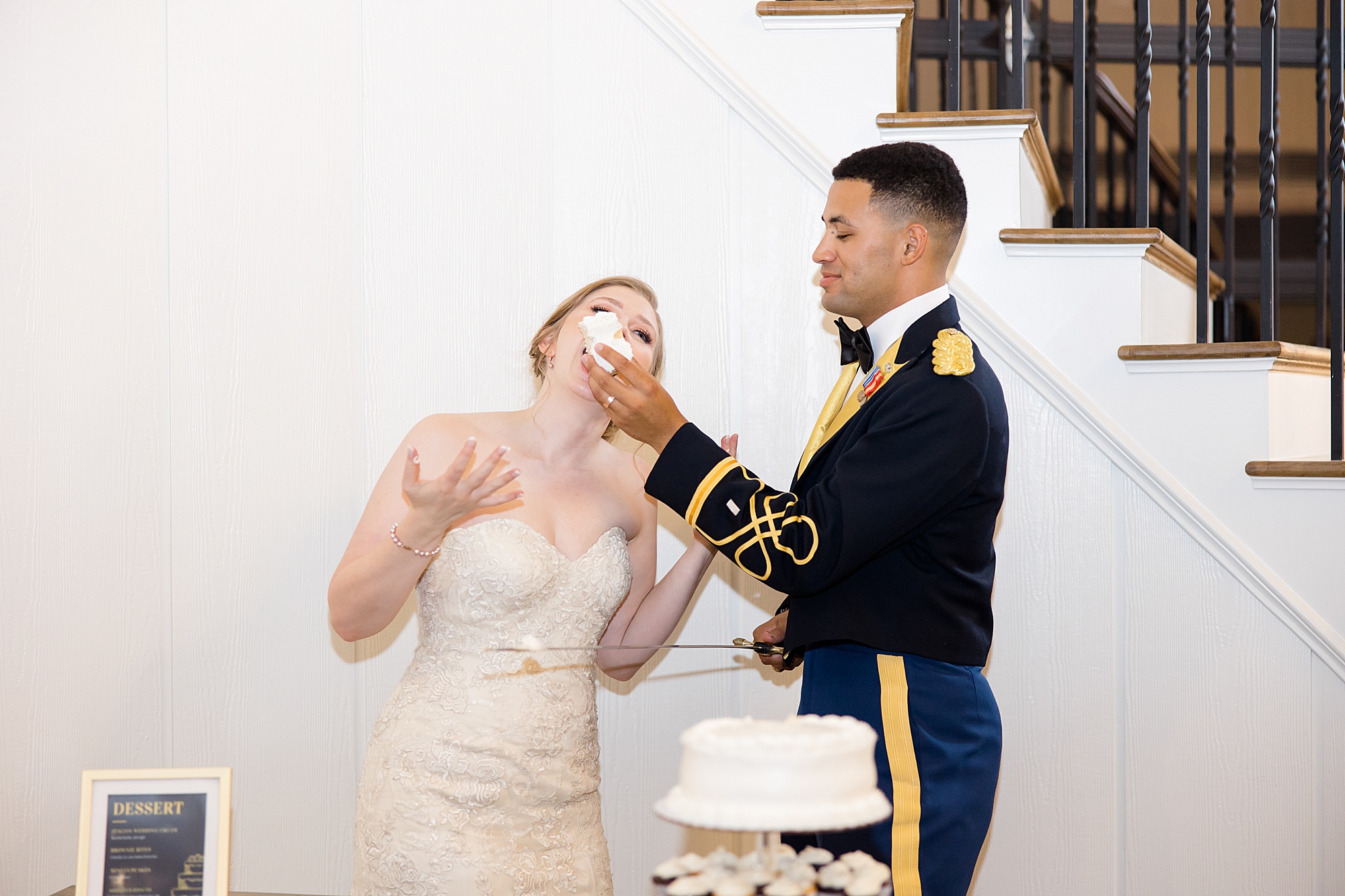 groom feeds bride cake during Bella Cavalli reception