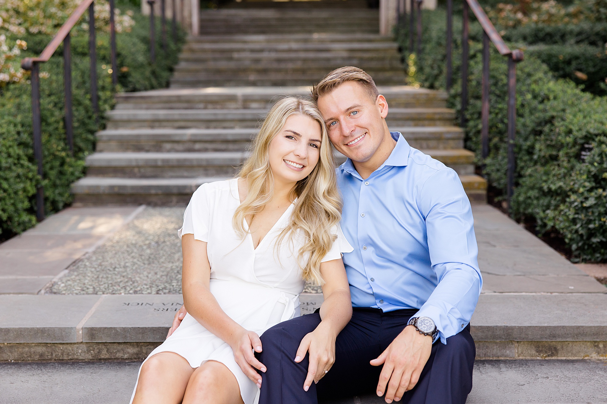bride and groom sit on steps together during Dallas photos