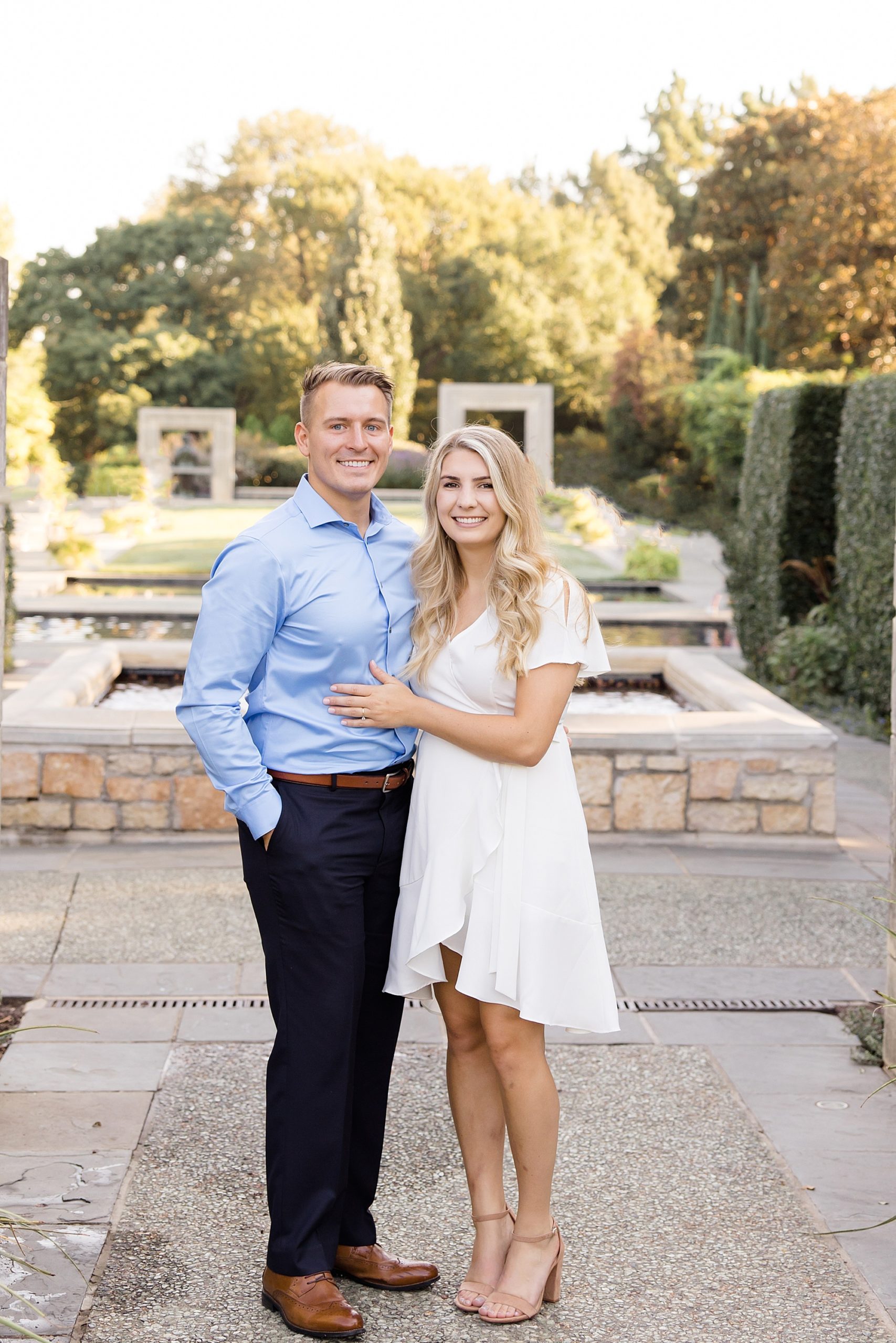 bride and groom pose together during Dallas Arboretum engagement portraits