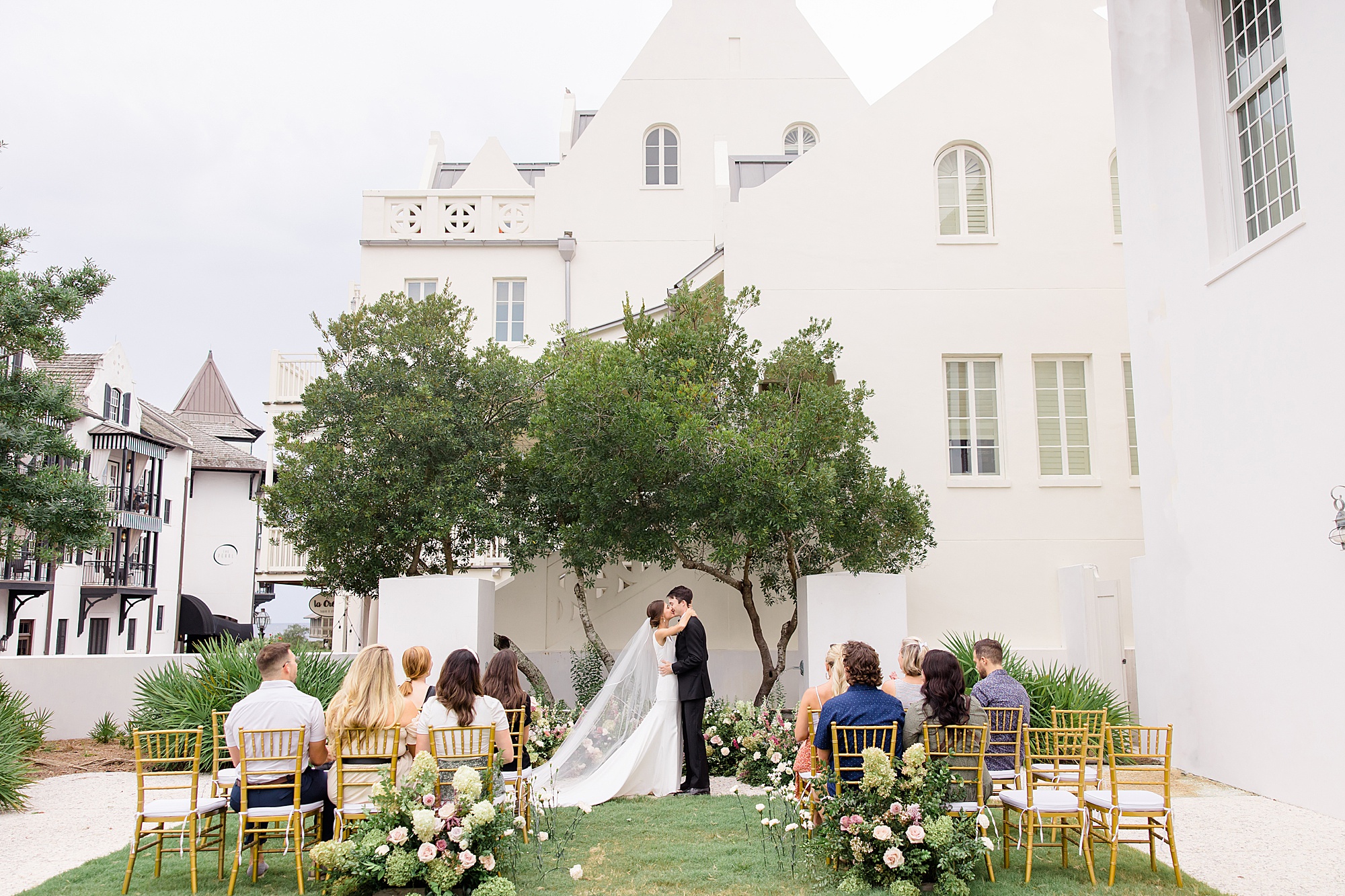 bride and groom kiss at ceremony site outside Rosemary Beach Town Hall