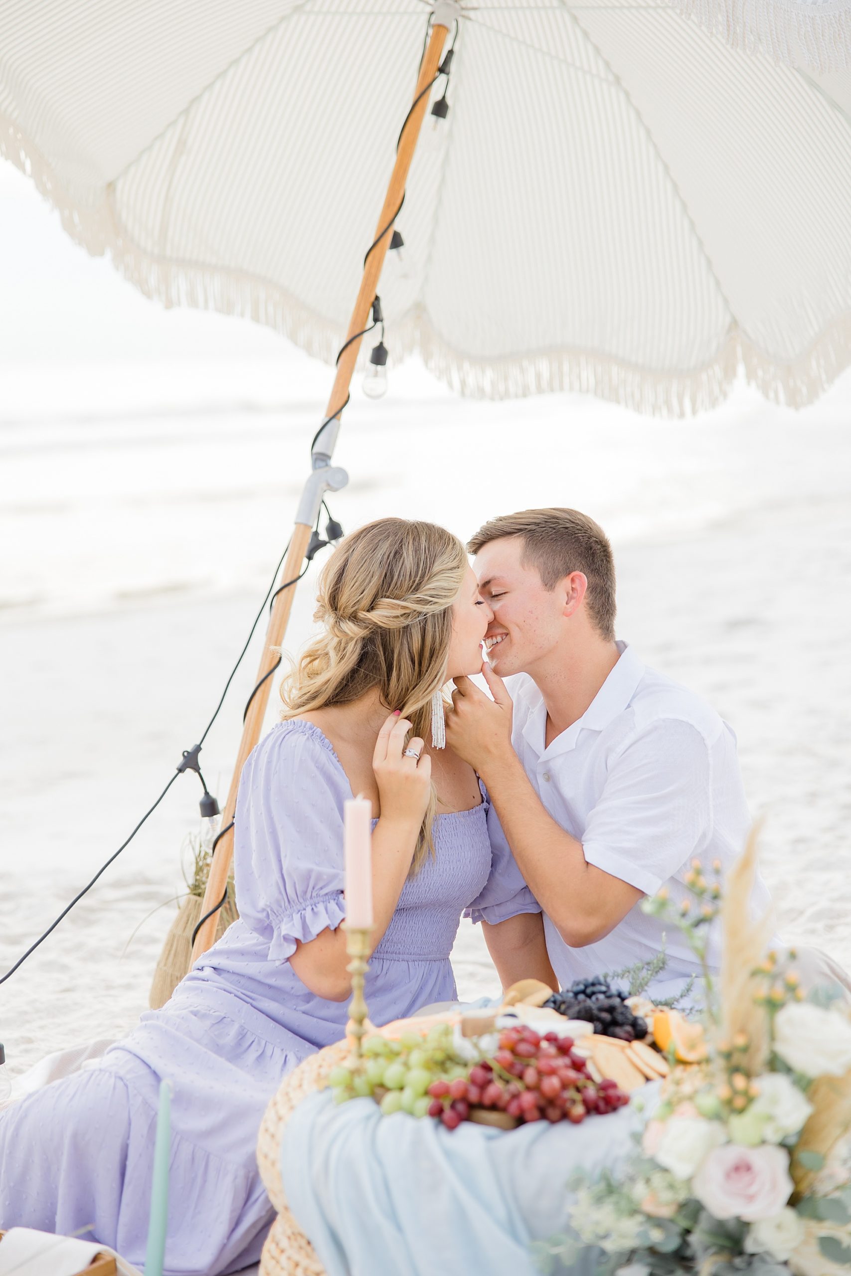 couple kisses during picnic on Rosemary Beach