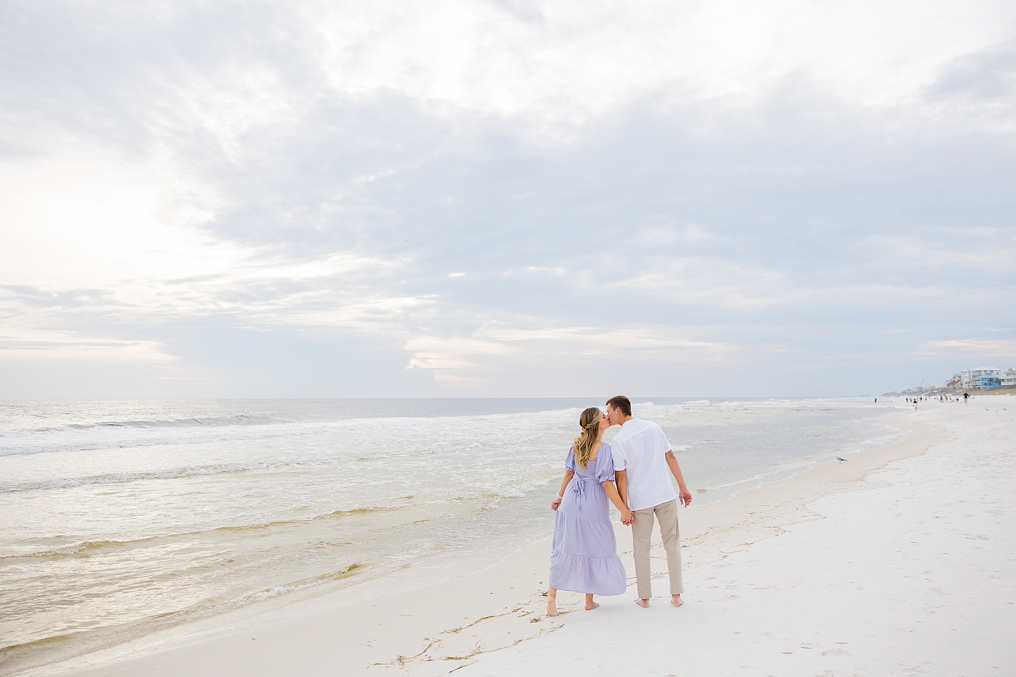 engaged couple kisses on beach in 30A