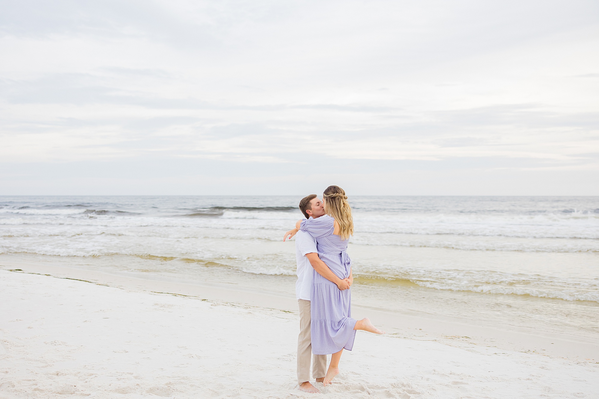 groom lifts bride during Rosemary Beach engagement session