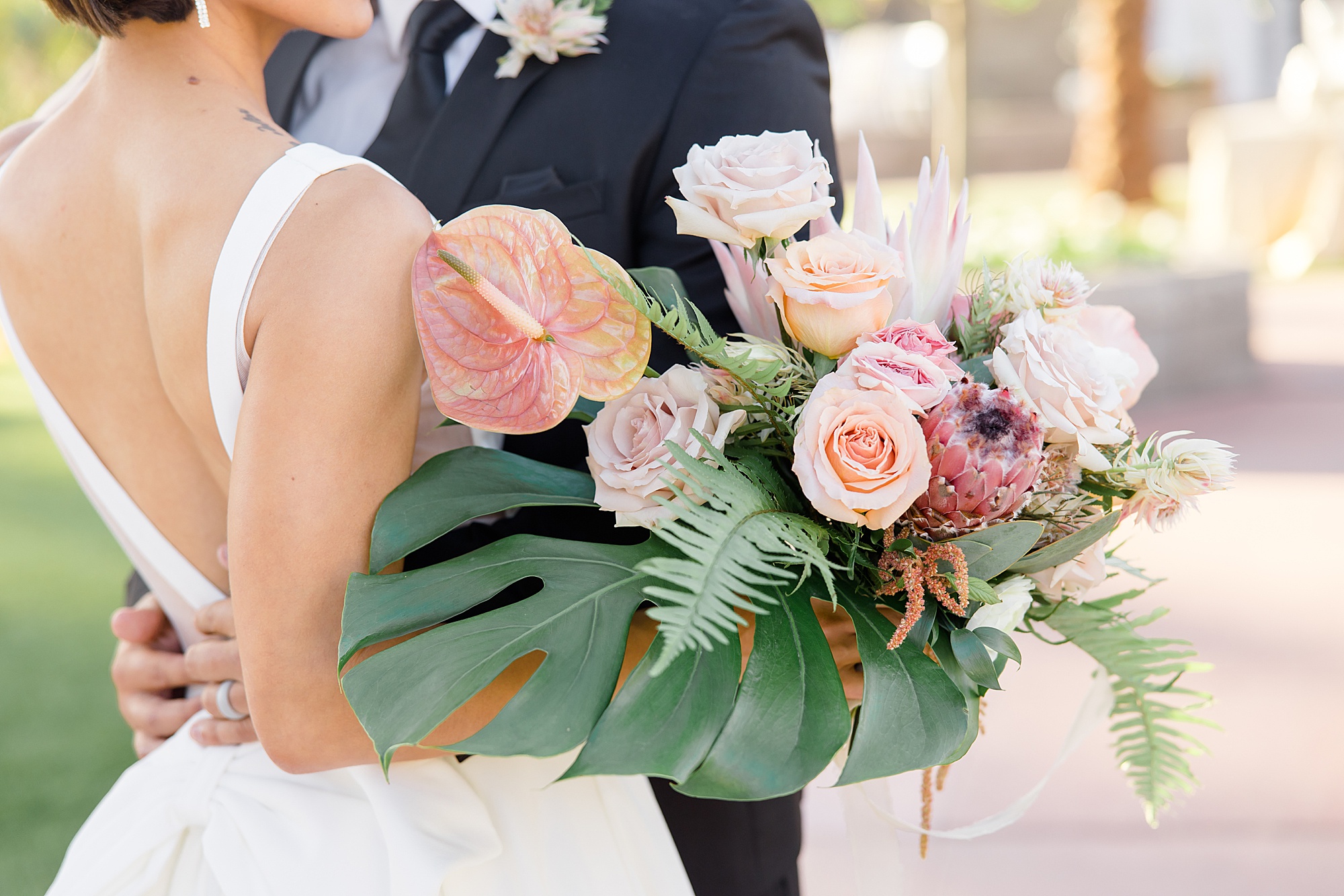 bride's tropical inspired wedding bouquet with pink and peach flowers