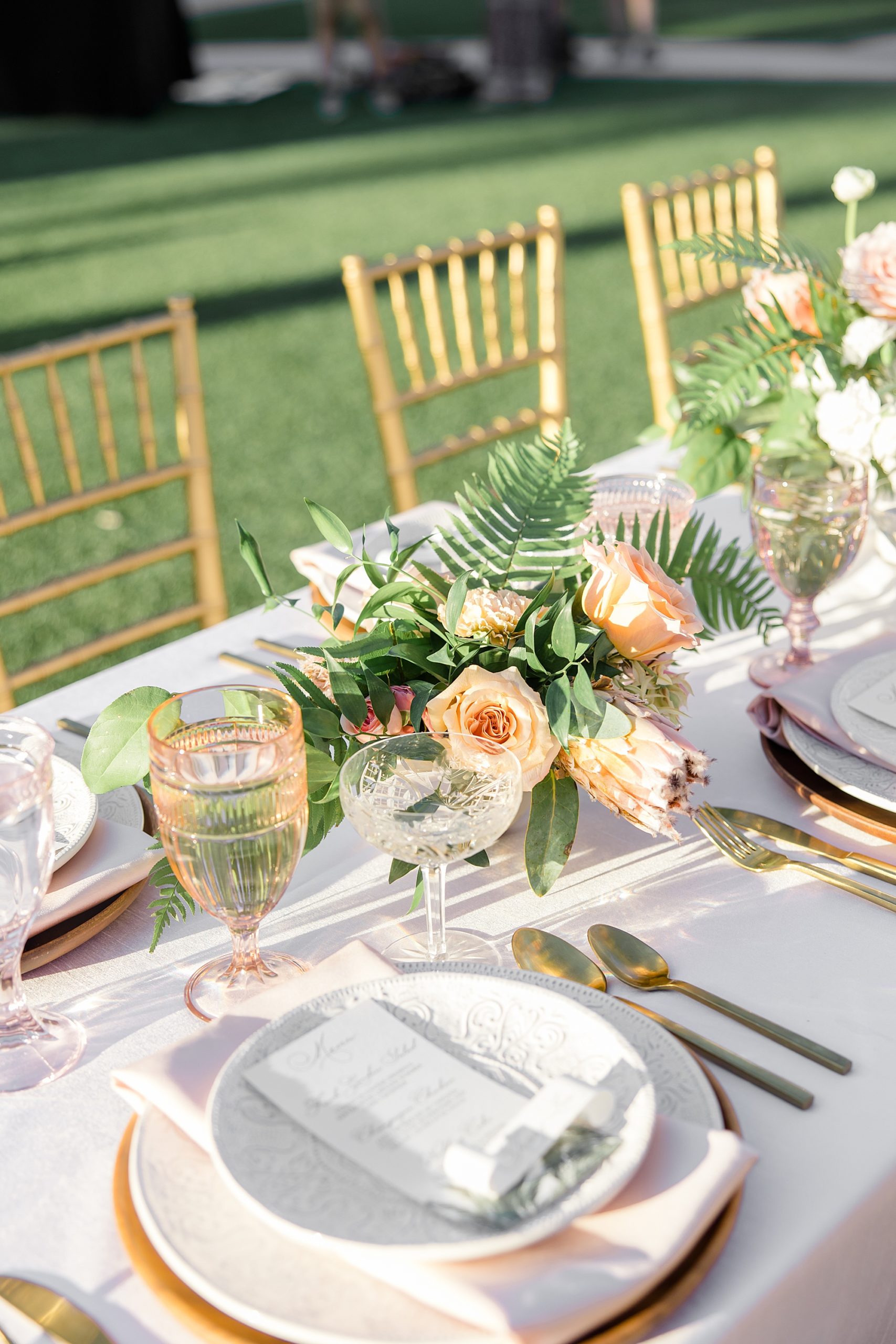 tropical inspired wedding reception with pink and gold details 