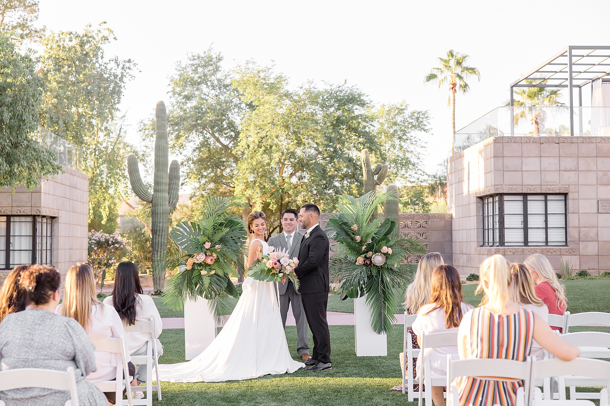 bride and groom listen to vows during desert inspired styled shoot ceremony 