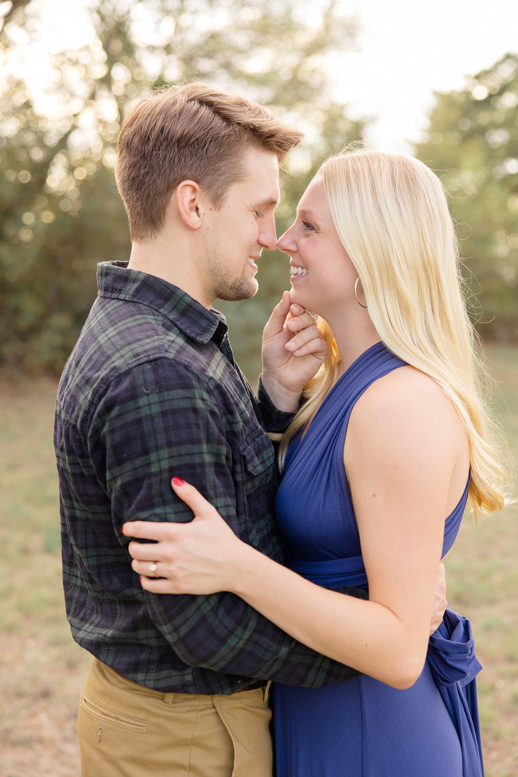 groom holds bride's chin during TX engagement session