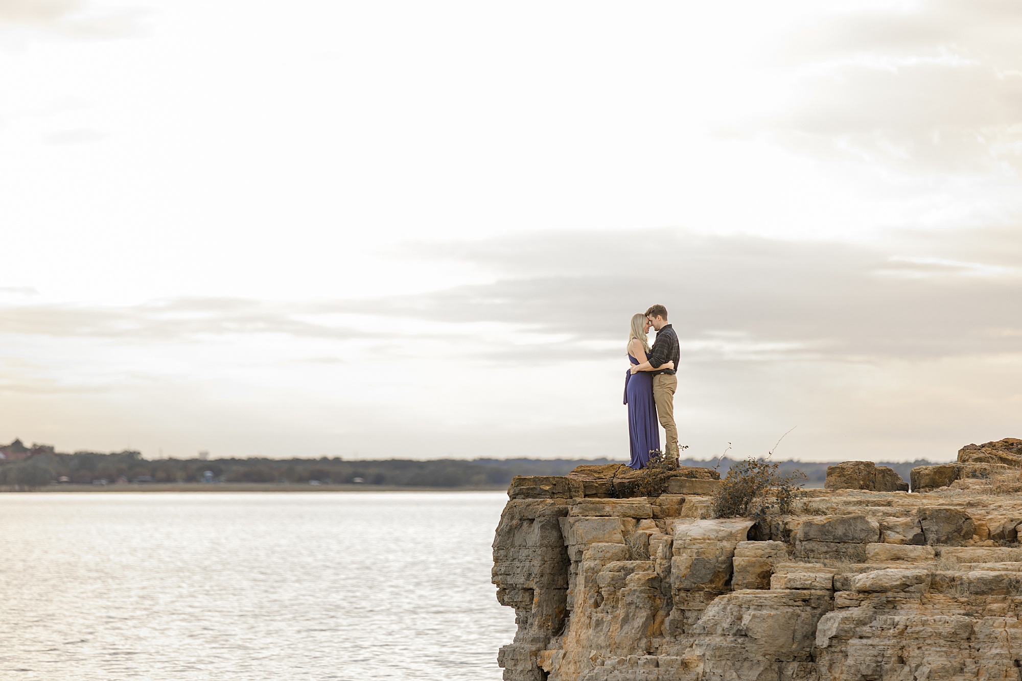 engaged couple stands on cliff in Grapevine, TX
