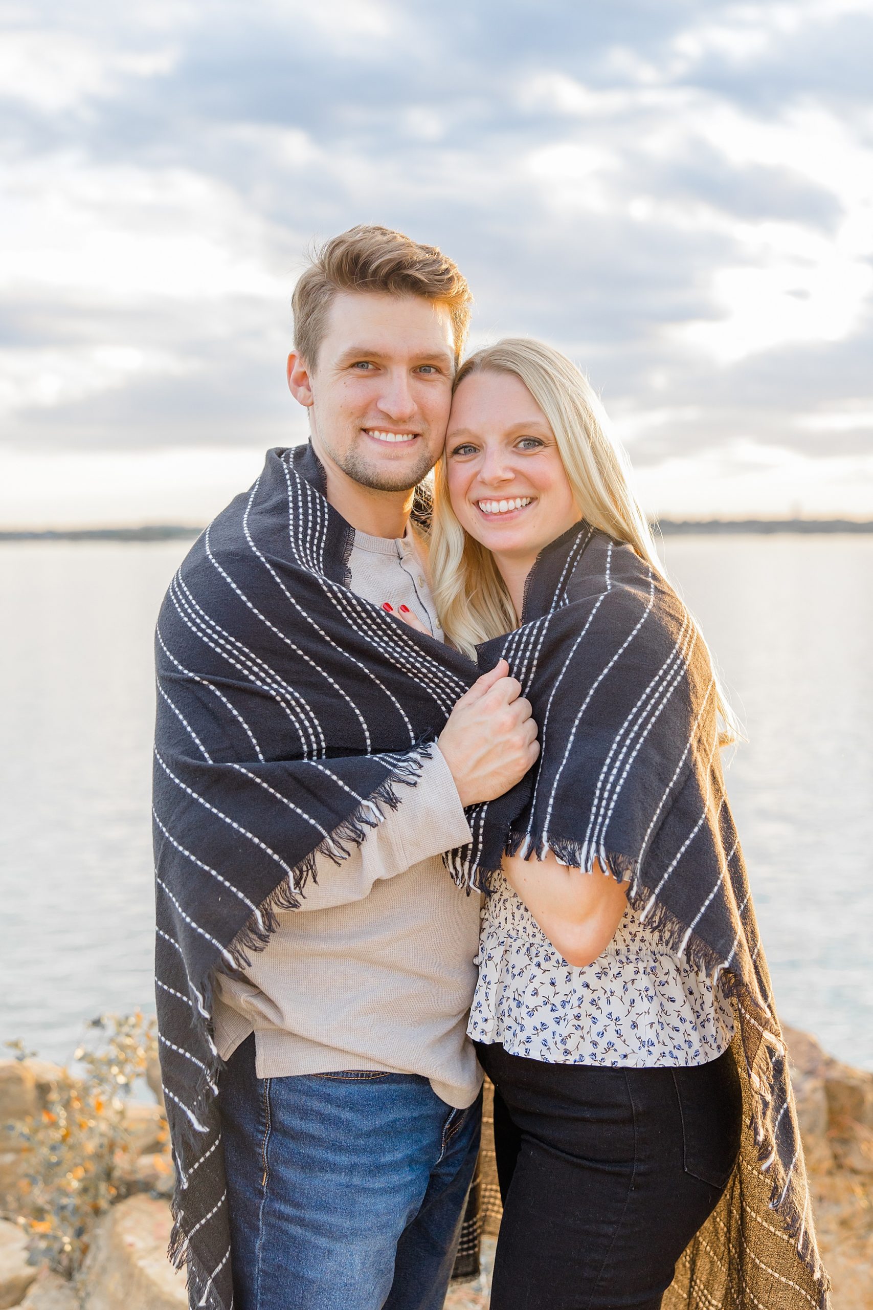 engaged couple stands on edge of Rockledge Park