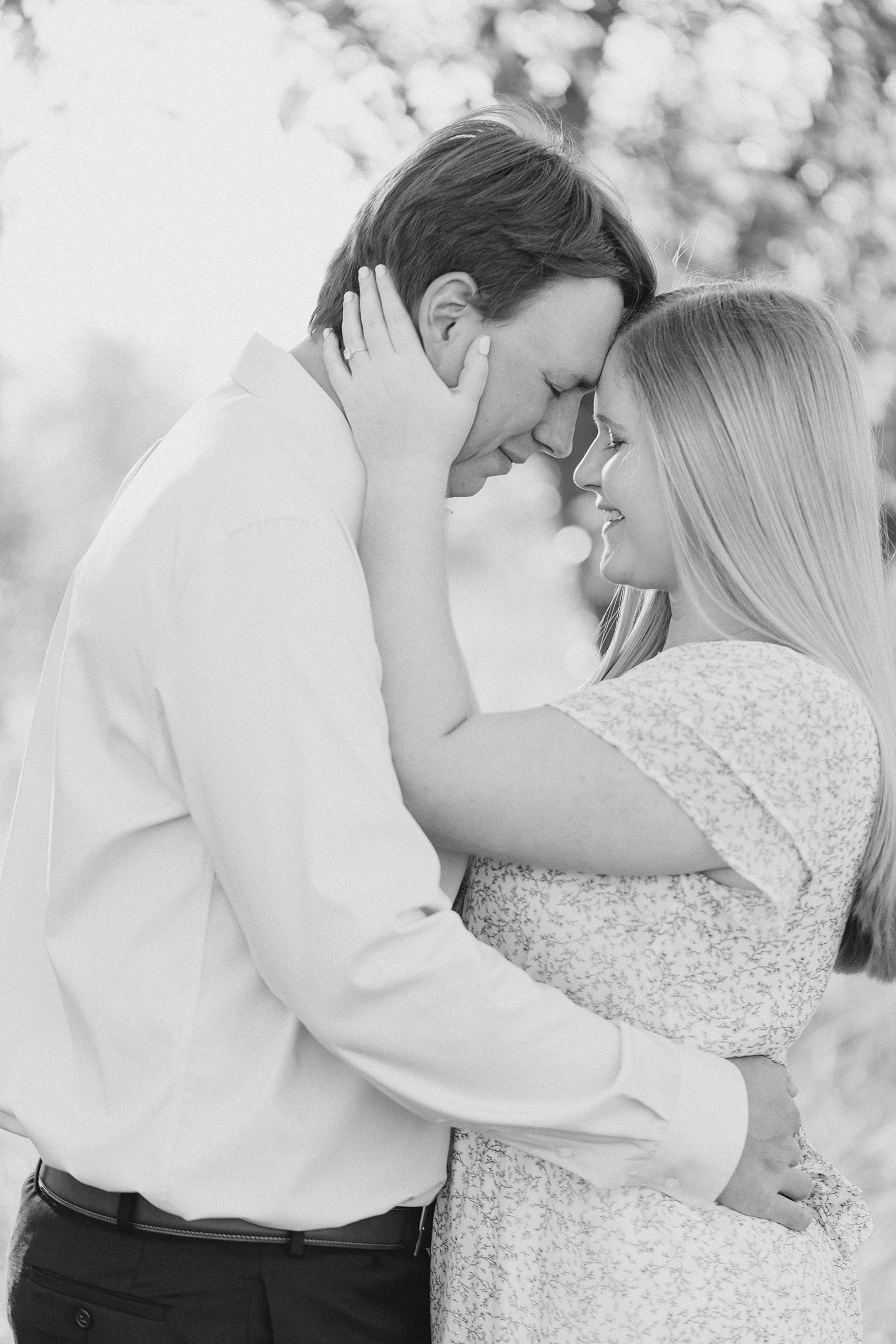 bride and groom stand touching noses during Ponder TX engagement session