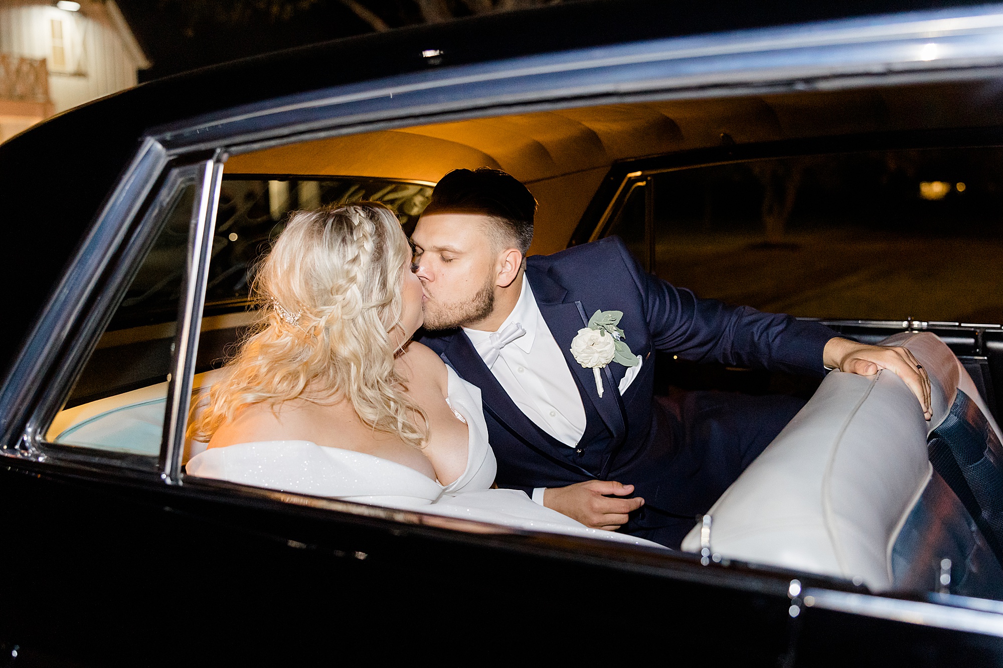bride and groom kiss in classic car after Ponder TX wedding reception