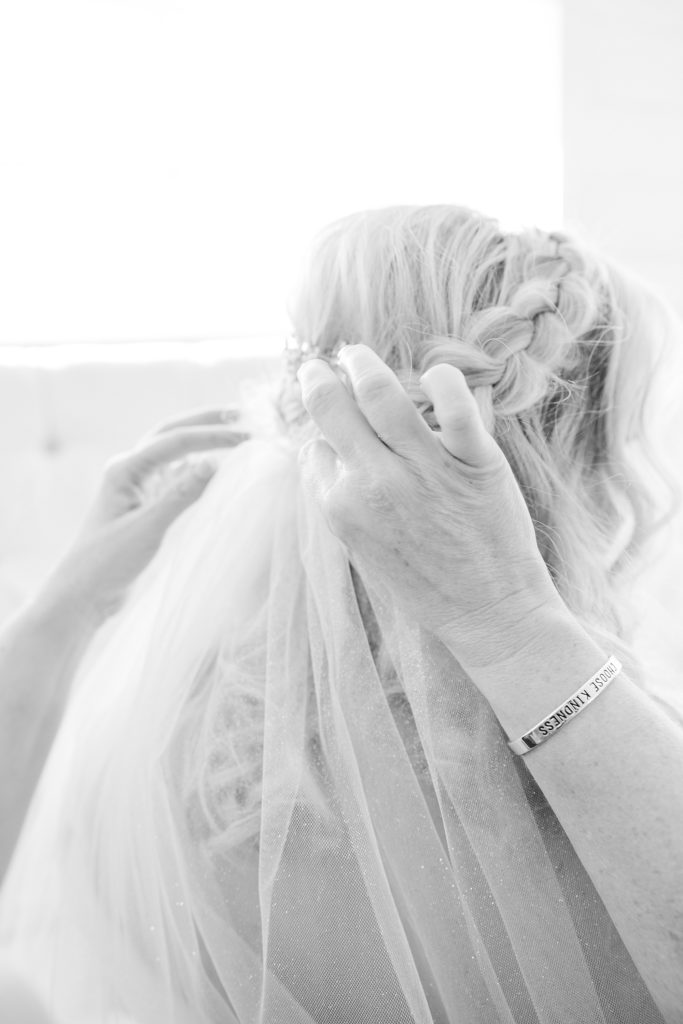 mother helps bride with veil on Texas wedding morning