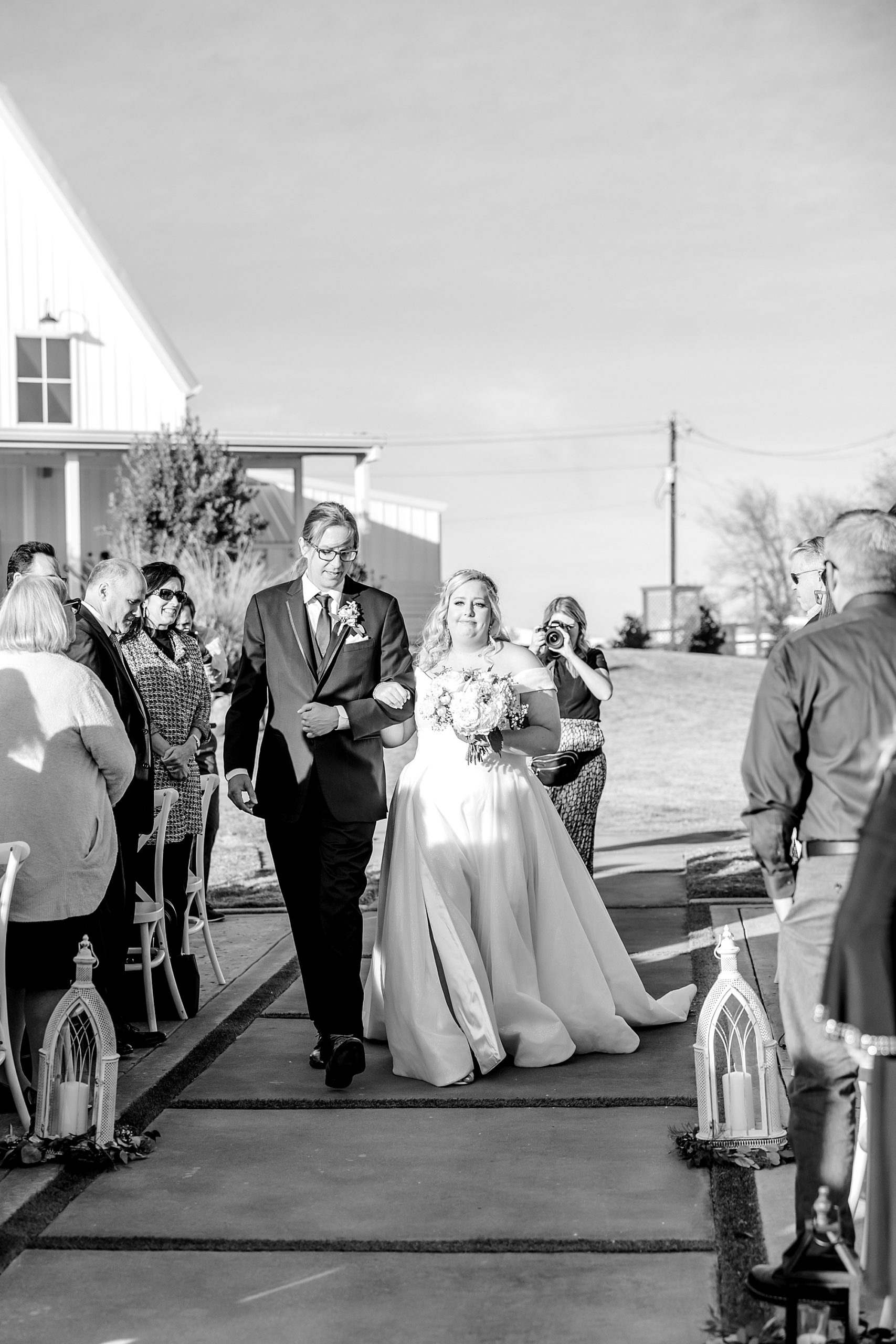 bride walks down the aisle with father for Ponder TX outdoor wedding ceremony