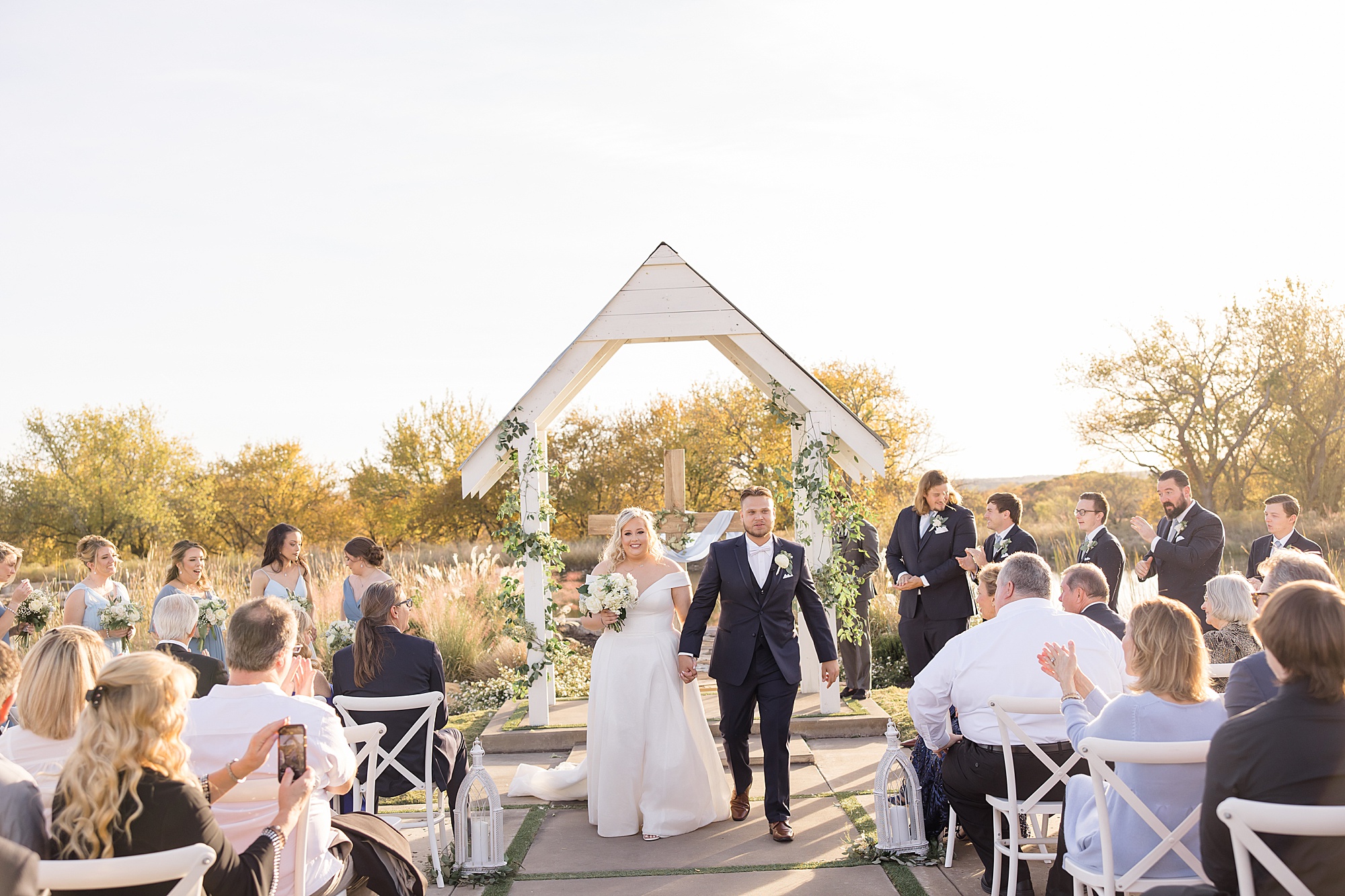 bride and groom walk up aisle after outdoor wedding ceremony in Texas