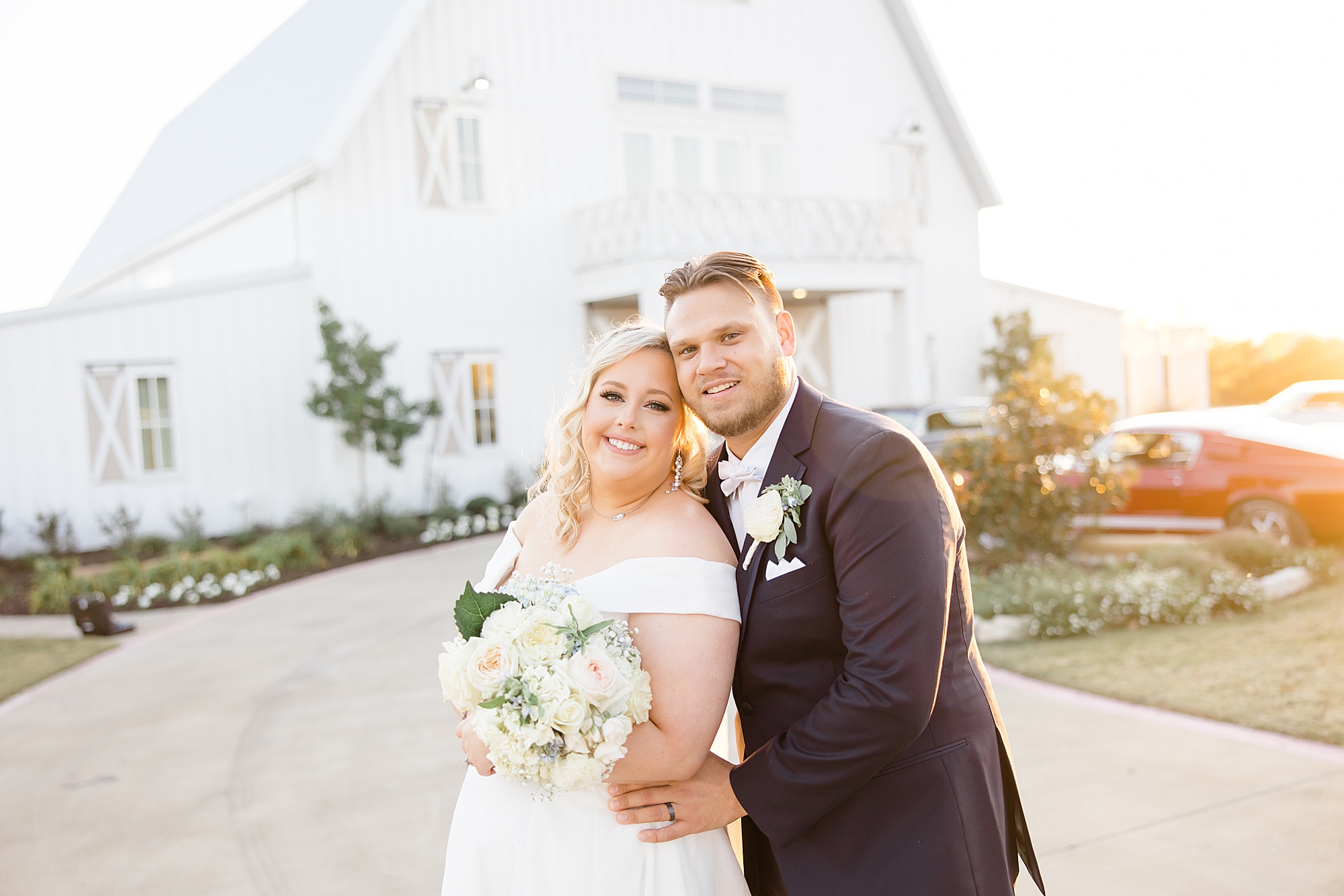 newlyweds pose outside the barn at the Nest at Ruth Farms