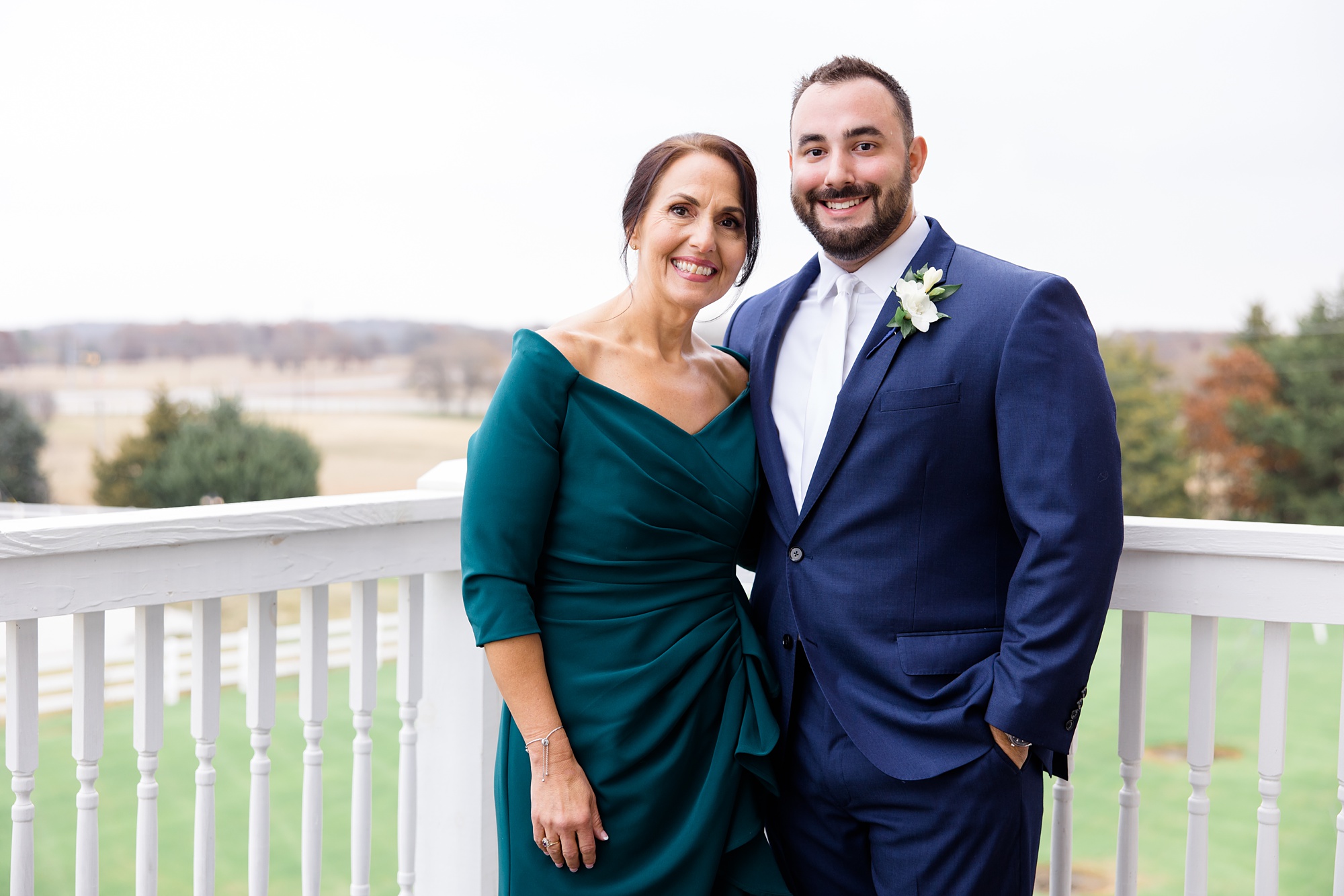 groom and mother pose on balcony at The Springs at Valley View