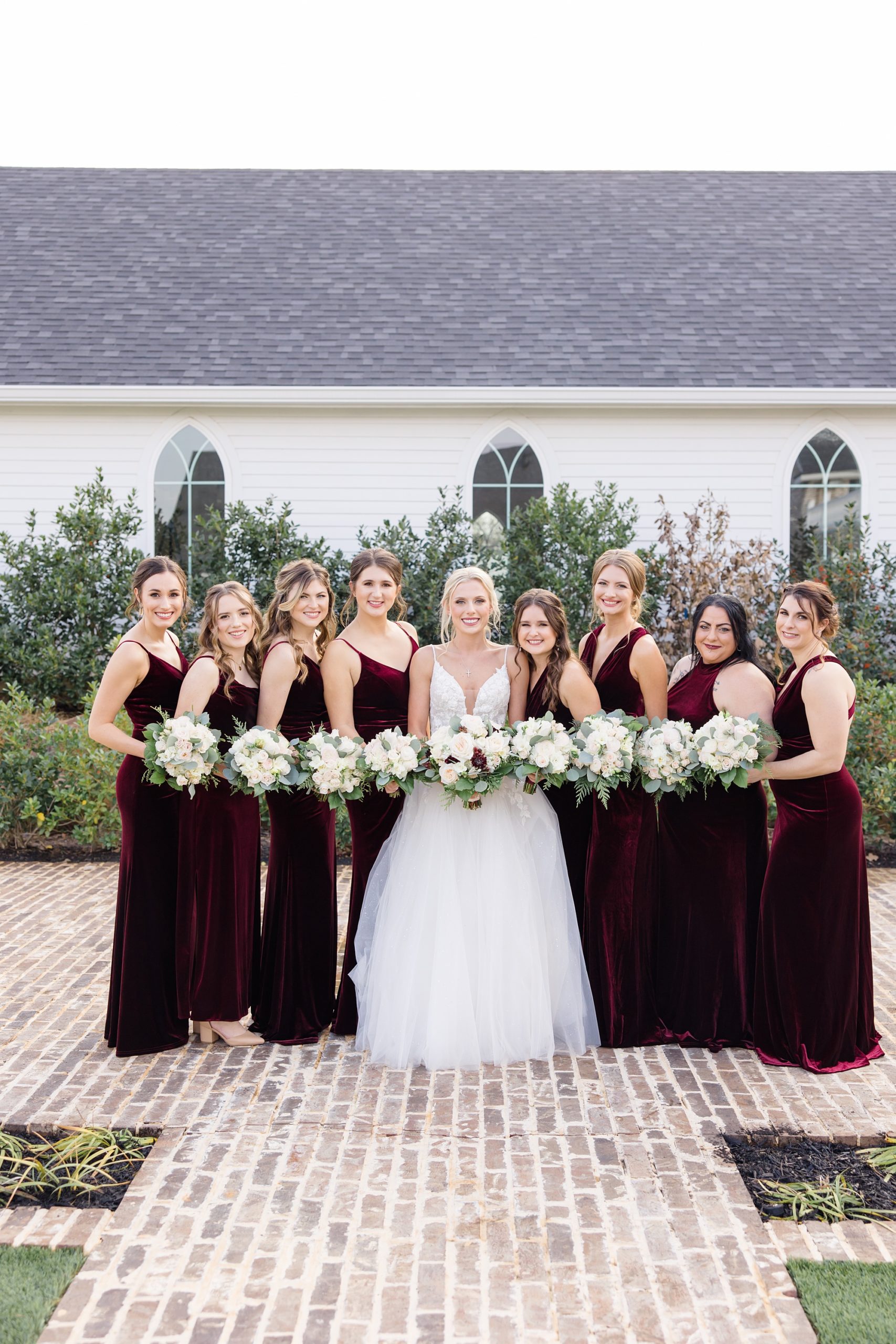 bride stands with bridesmaids outside The Springs at Valley View