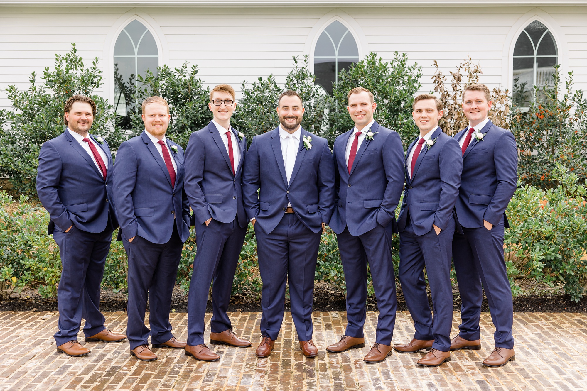 groom and groomsmen pose by The Springs at Valley View