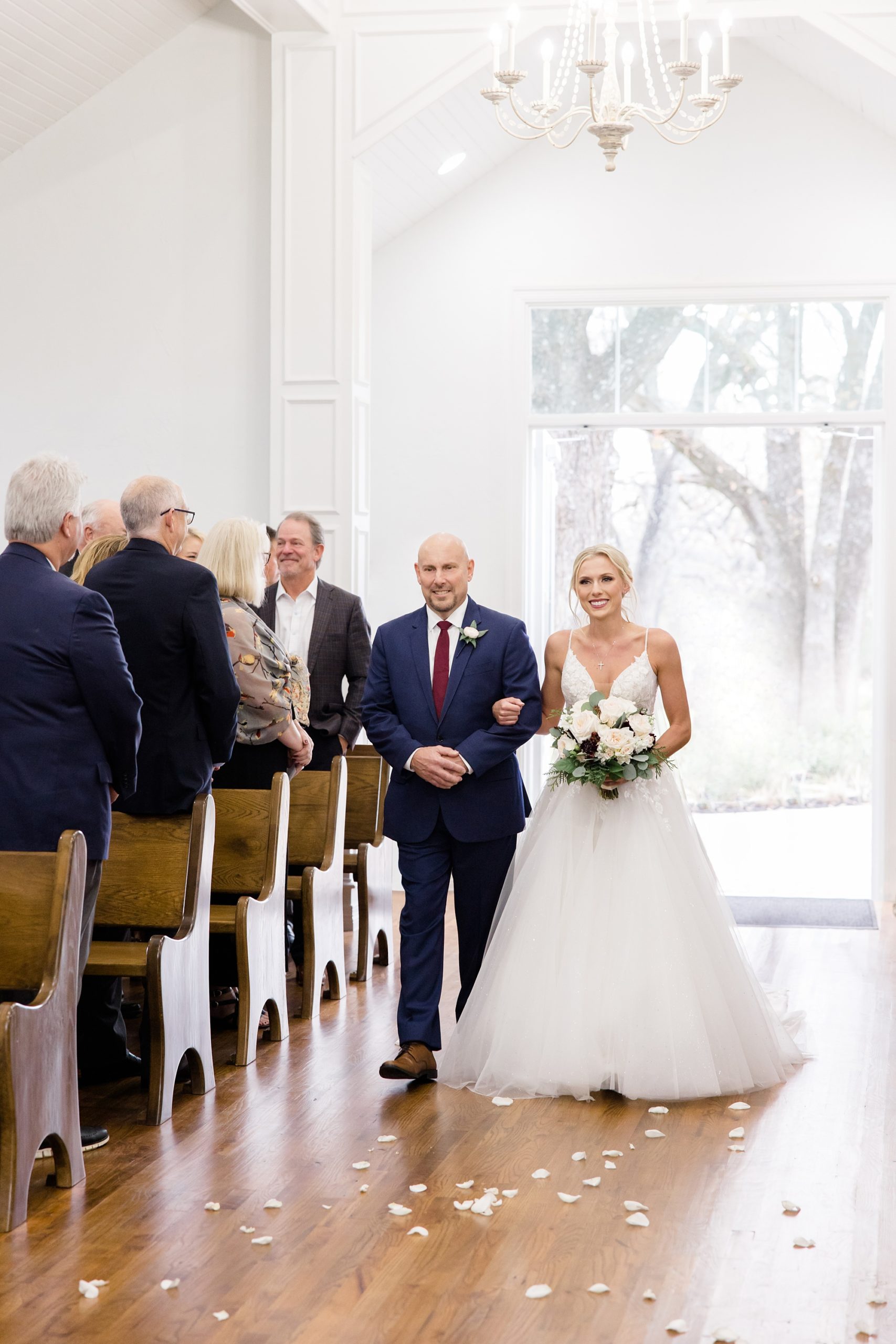 bride walks down aisle with dad during Valley View TX wedding ceremony