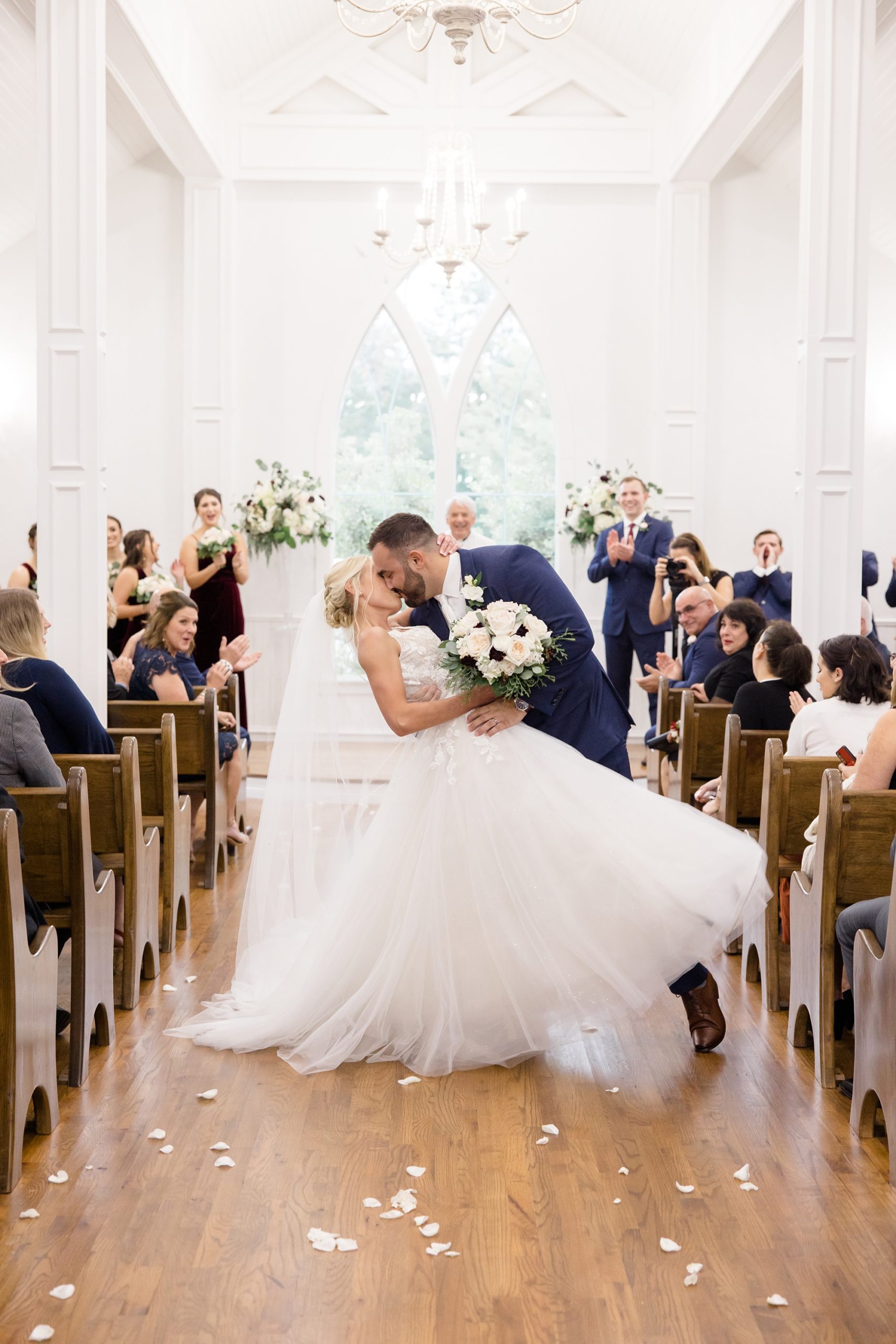 bride and groom kiss up aisle during Valley View TX wedding ceremony