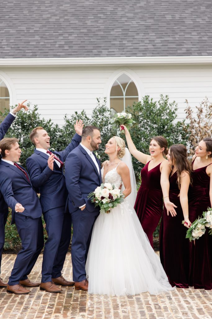 newlyweds smile while bridal party cheers