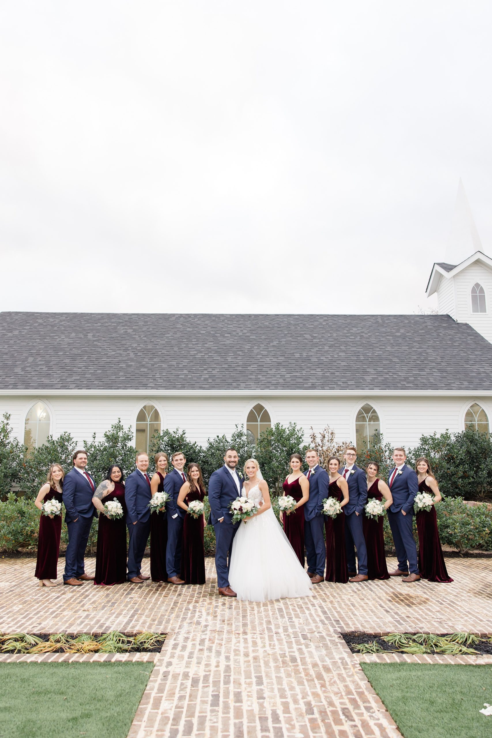 bride and groom stand with wedding party for Texas celebration 