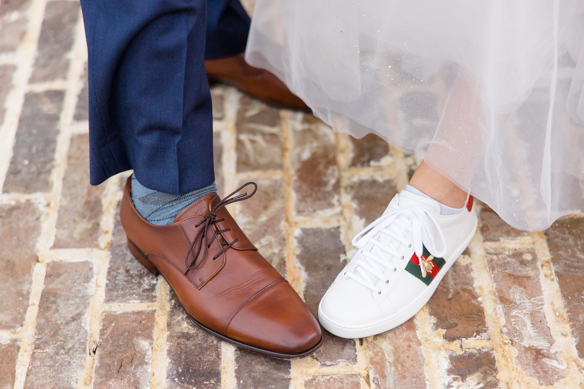 bride and groom show off custom shoes