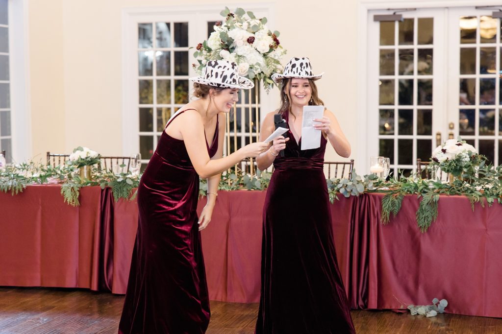 bridesmaids laugh giving toasts in cow cowboy hats 