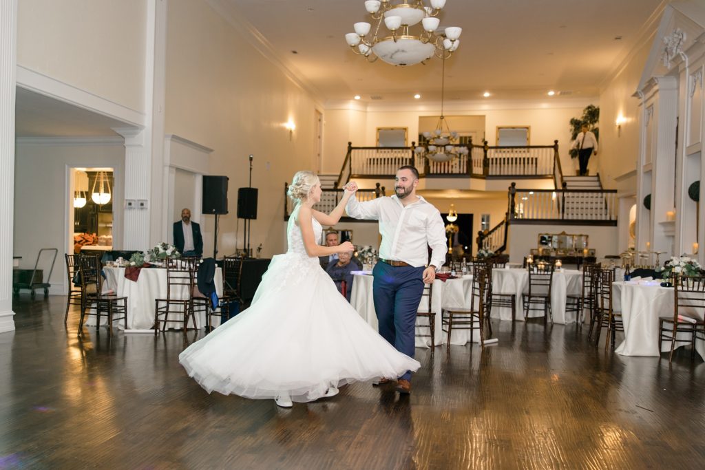 groom twirls bride during private last dance at Valley View TX wedding reception