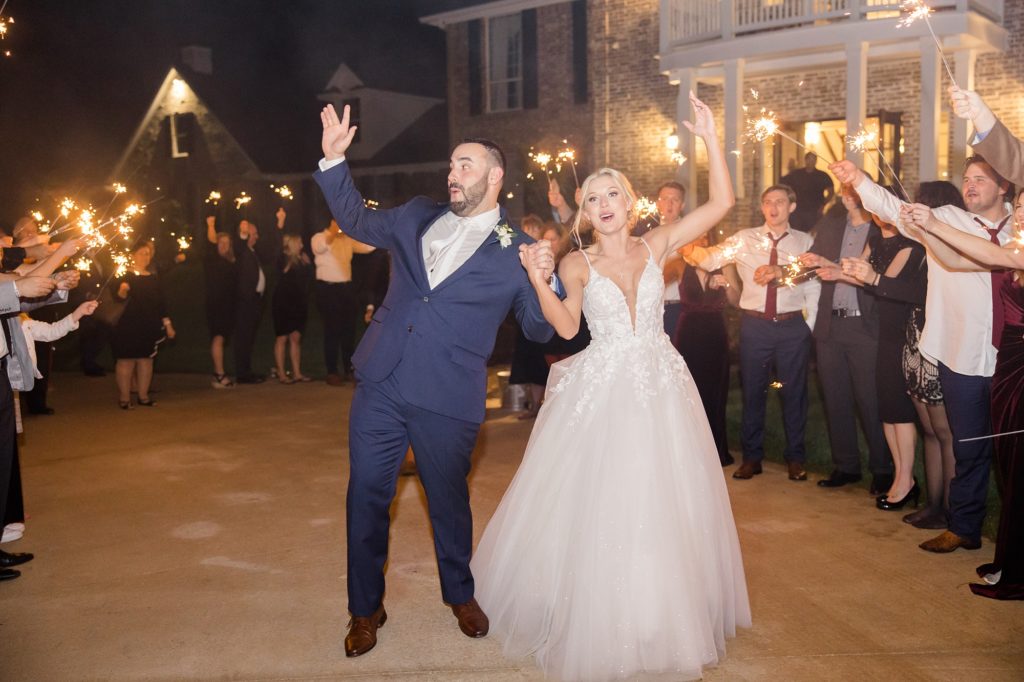 bride and groom wave to guests during sparkler exit