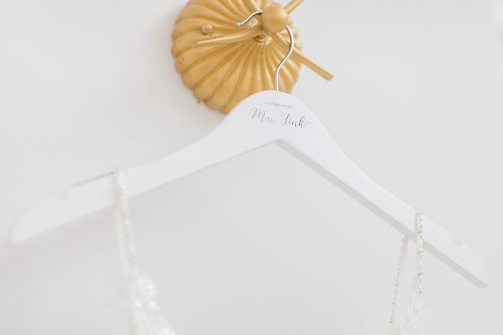 bride's custom hanger for wedding gown on gold hook at The Nest at Ruth Farms