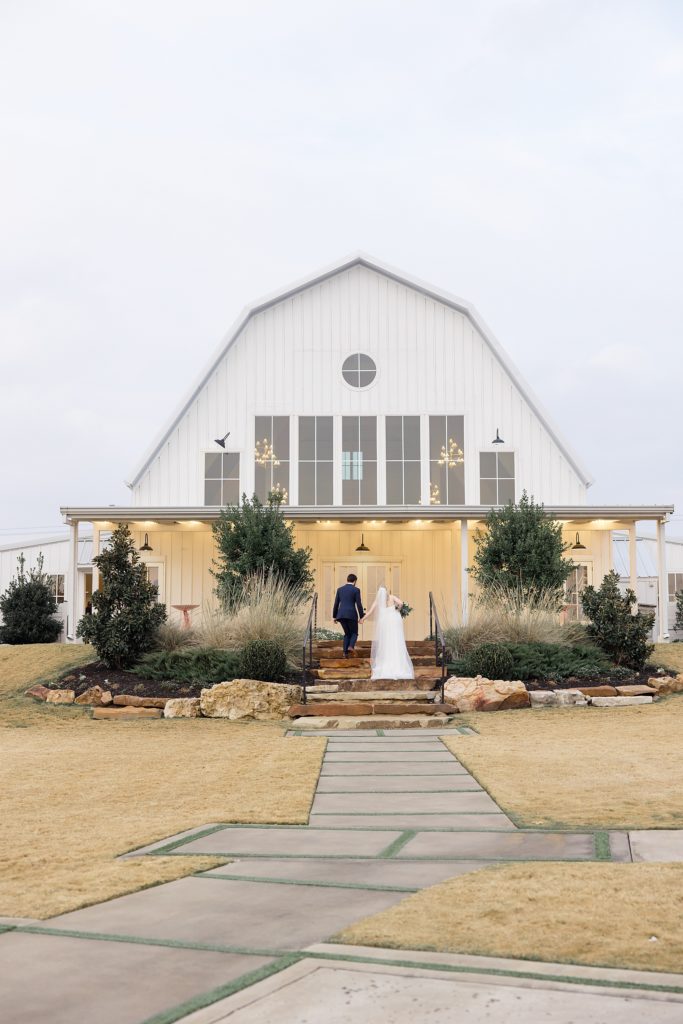 couple walks up steps for reception at The Nest at Ruth Farms
