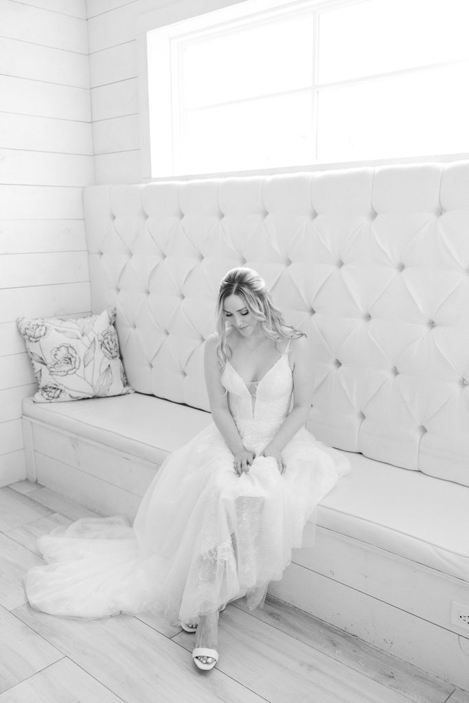 bride sits on couch in bridal suite at The Nest at Ruth Farms